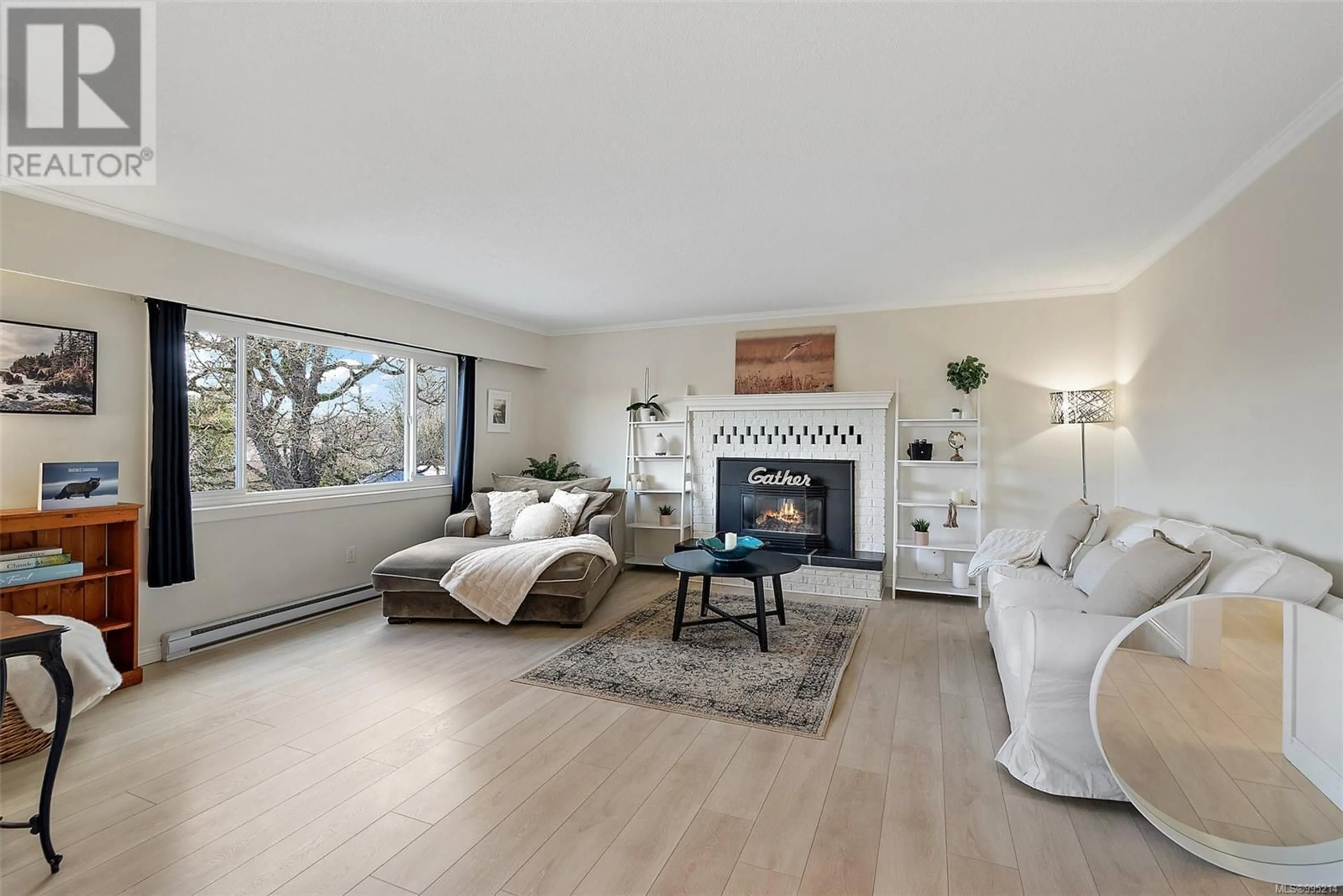 Living room with furniture, wood/laminate floor for 3874 LANCASTER ROAD, Saanich British Columbia V8X2B3