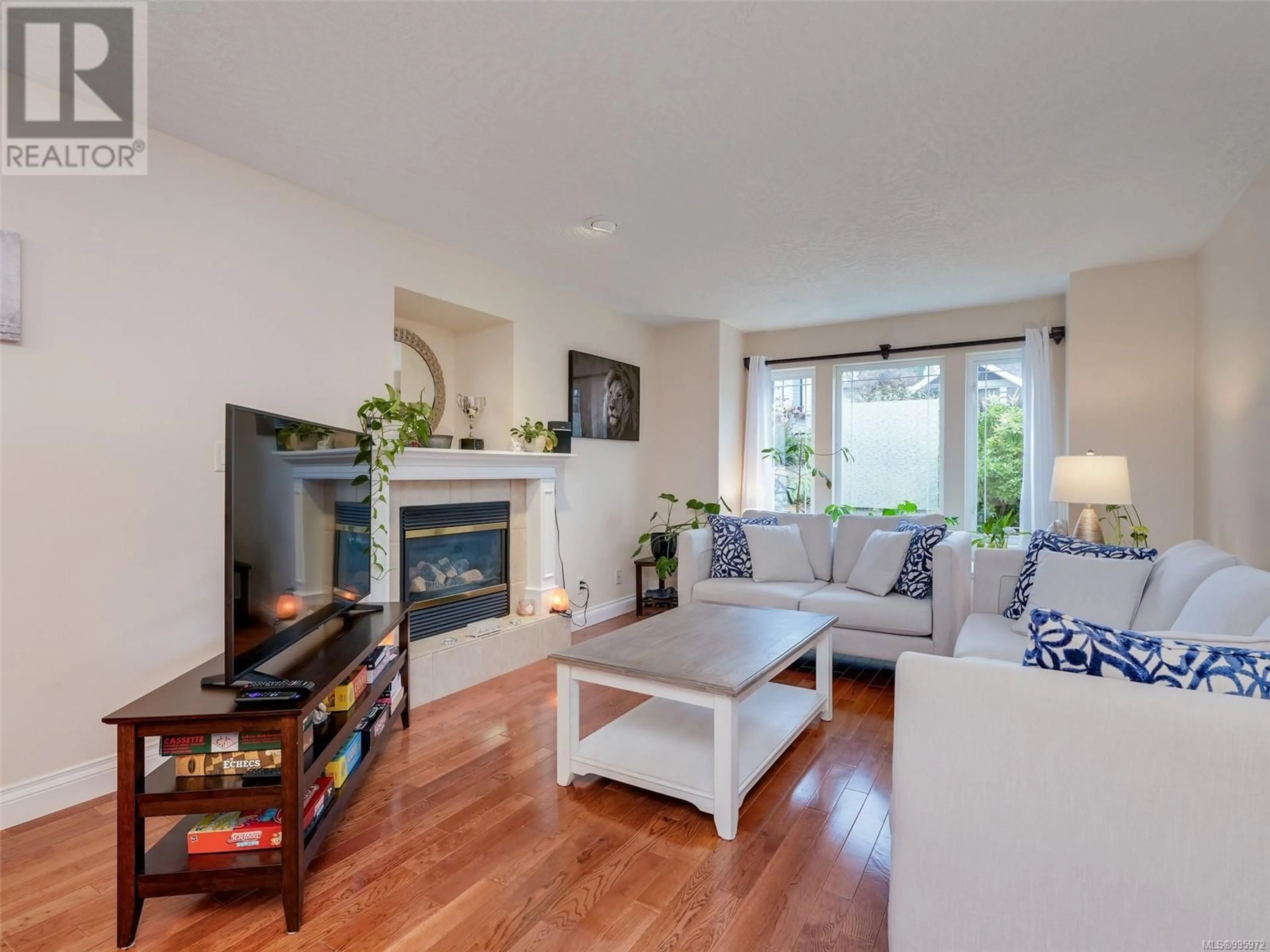Living room with furniture, wood/laminate floor for 4040 BLACKBERRY LANE, Saanich British Columbia V8X5J4