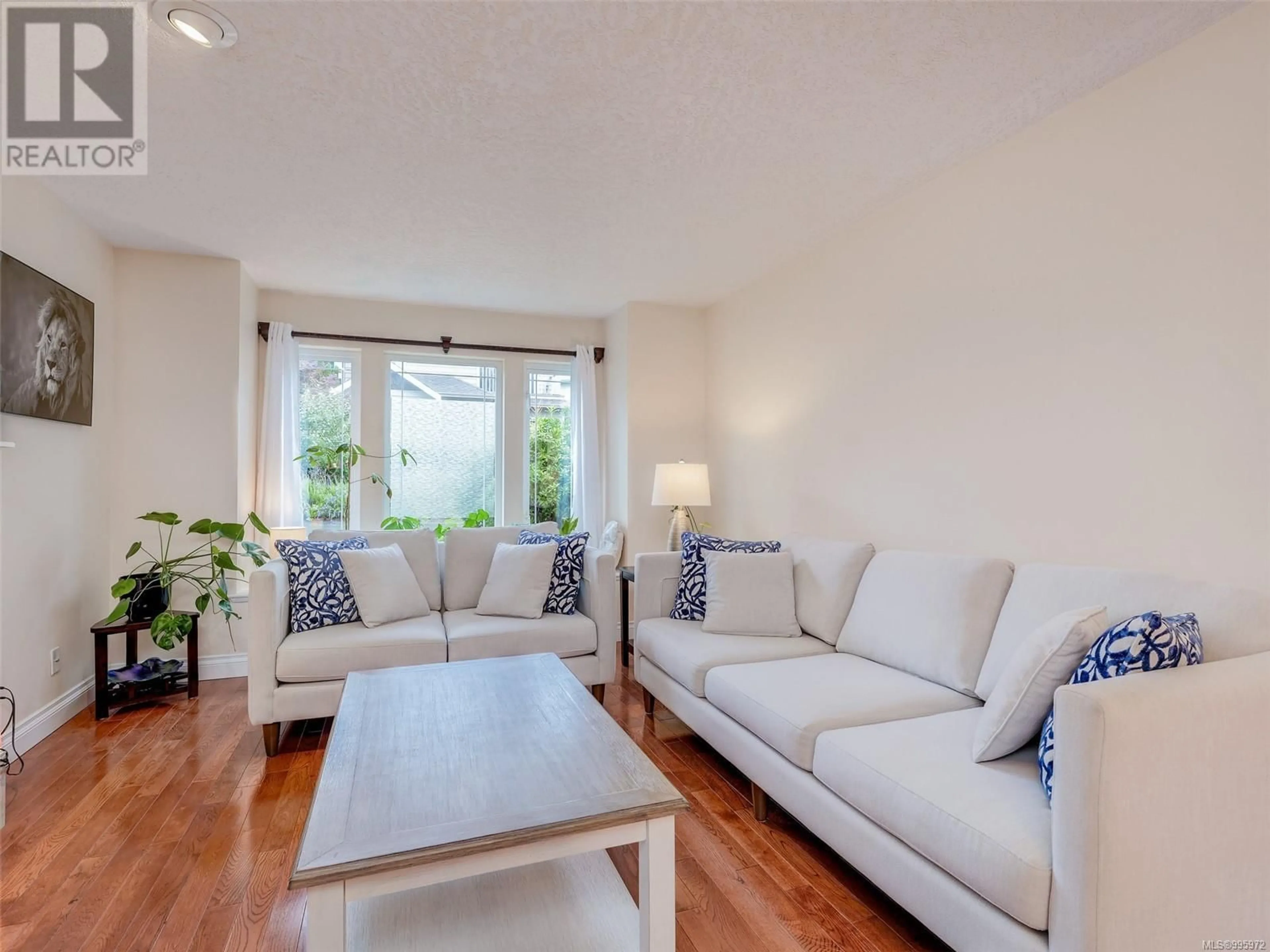 Living room with furniture, wood/laminate floor for 4040 BLACKBERRY LANE, Saanich British Columbia V8X5J4