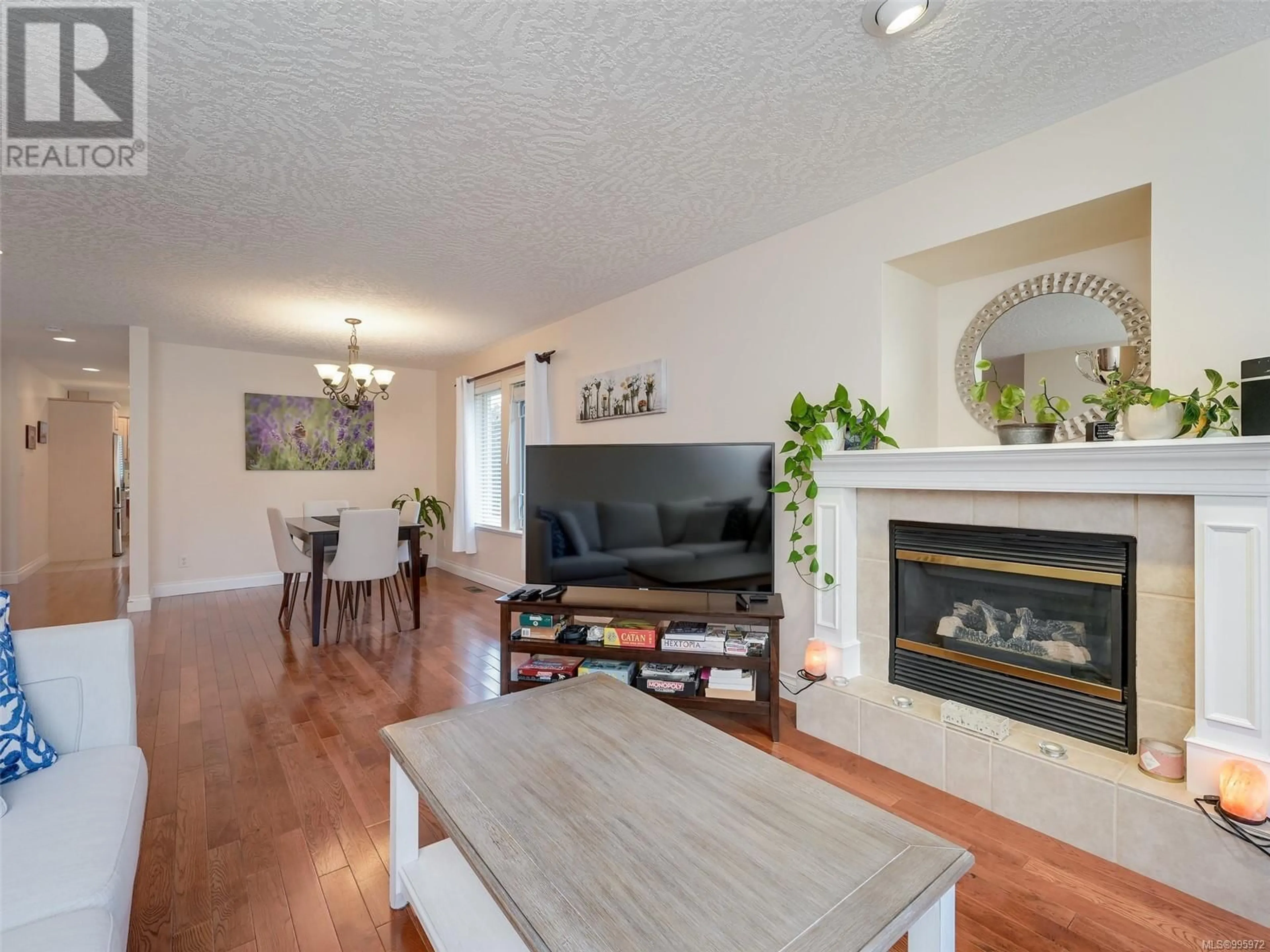 Living room with furniture, wood/laminate floor for 4040 BLACKBERRY LANE, Saanich British Columbia V8X5J4