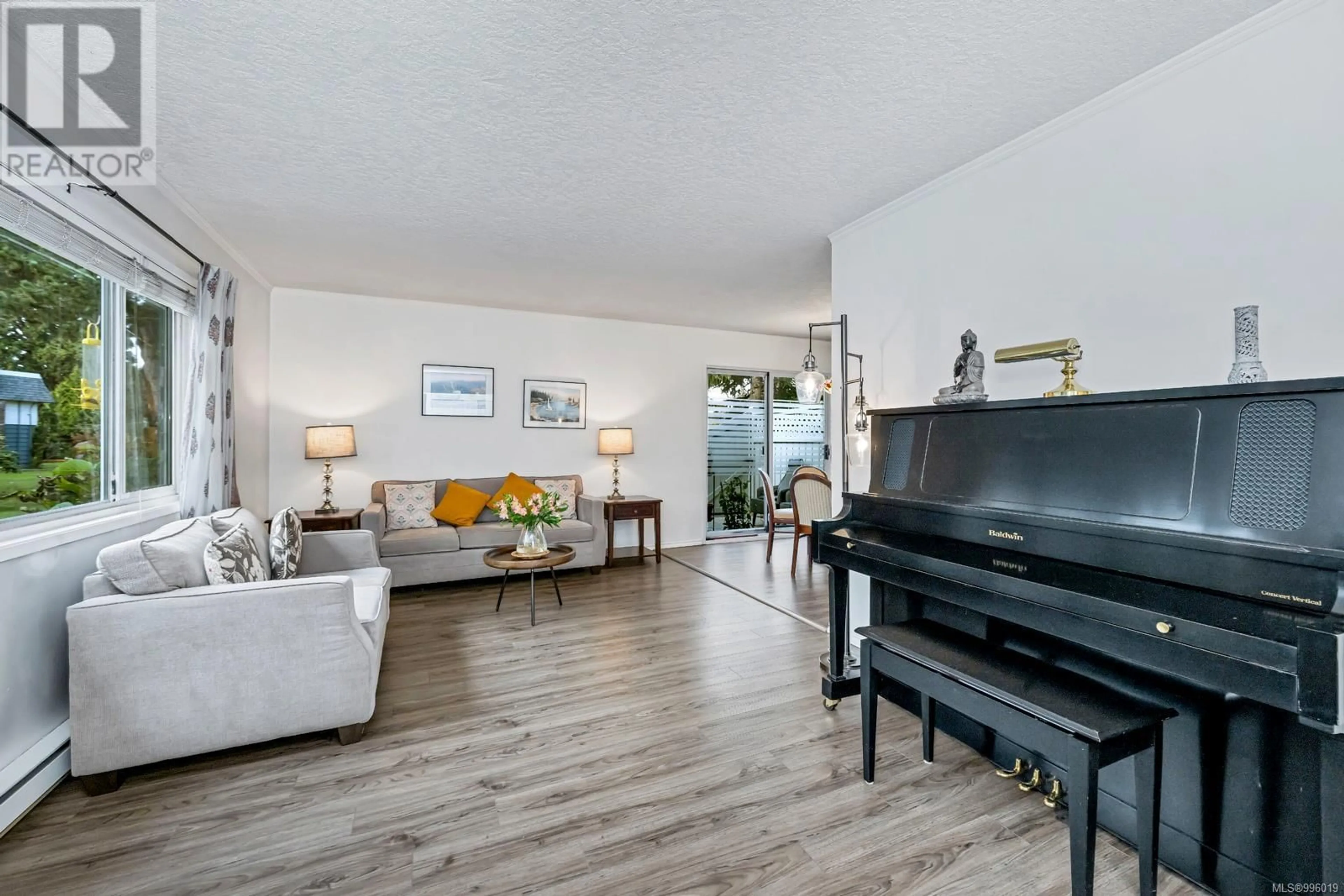 Living room with furniture, wood/laminate floor for 22 - 4058 CORNERS PLACE, Saanich British Columbia V8X3Z5