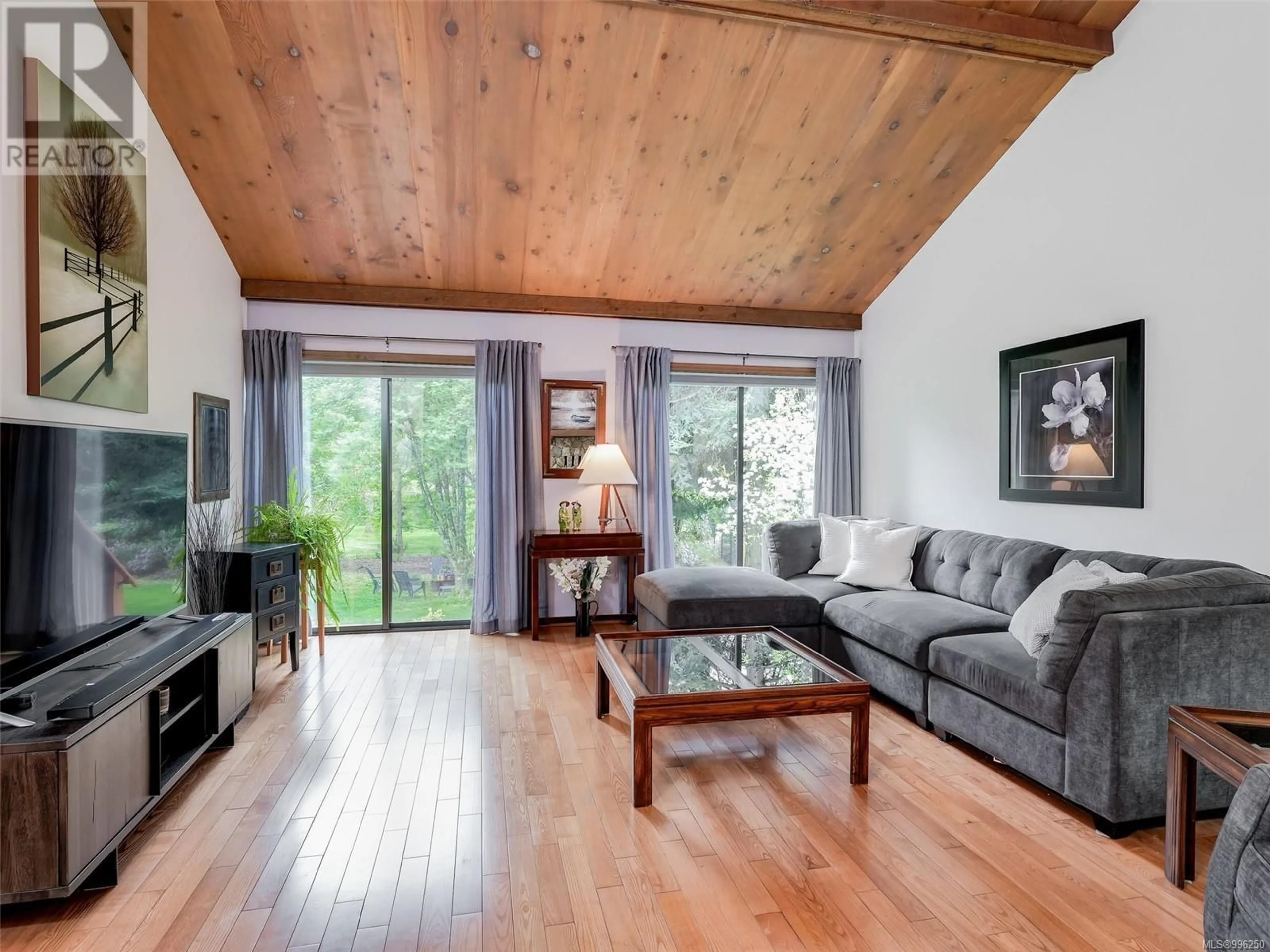 Living room with furniture, wood/laminate floor for 1647 STUART PARK TERRACE, North Saanich British Columbia V8L4R6