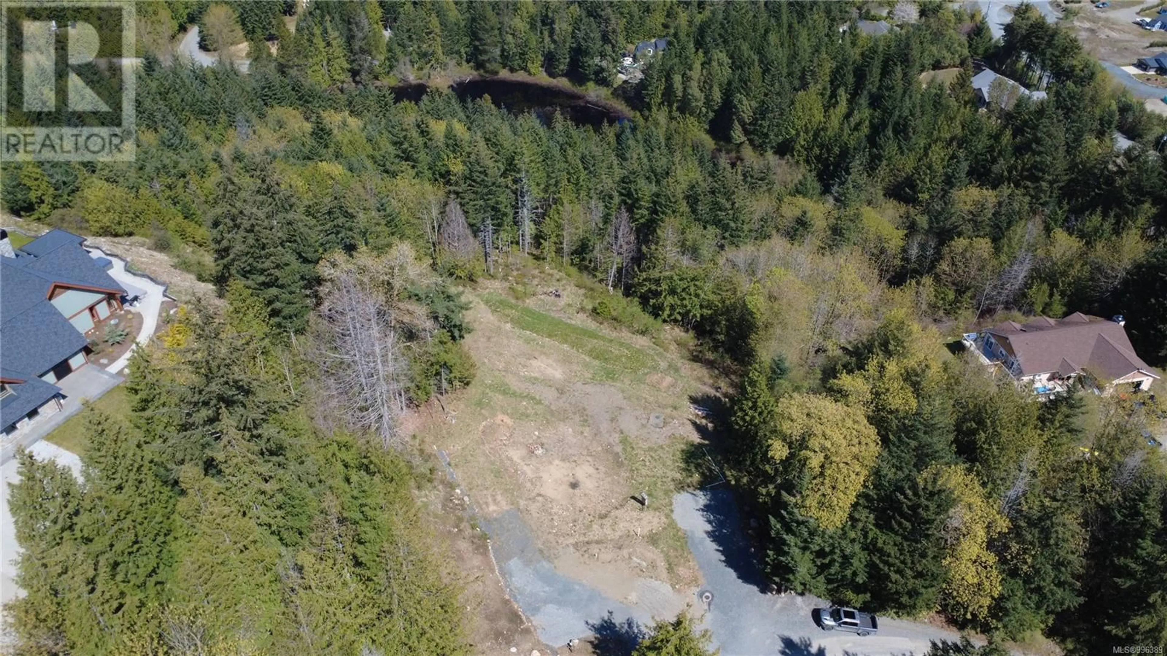 A pic from outside/outdoor area/front of a property/back of a property/a pic from drone, forest/trees view for 1725 WARN WAY, Qualicum Beach British Columbia V9K2S3