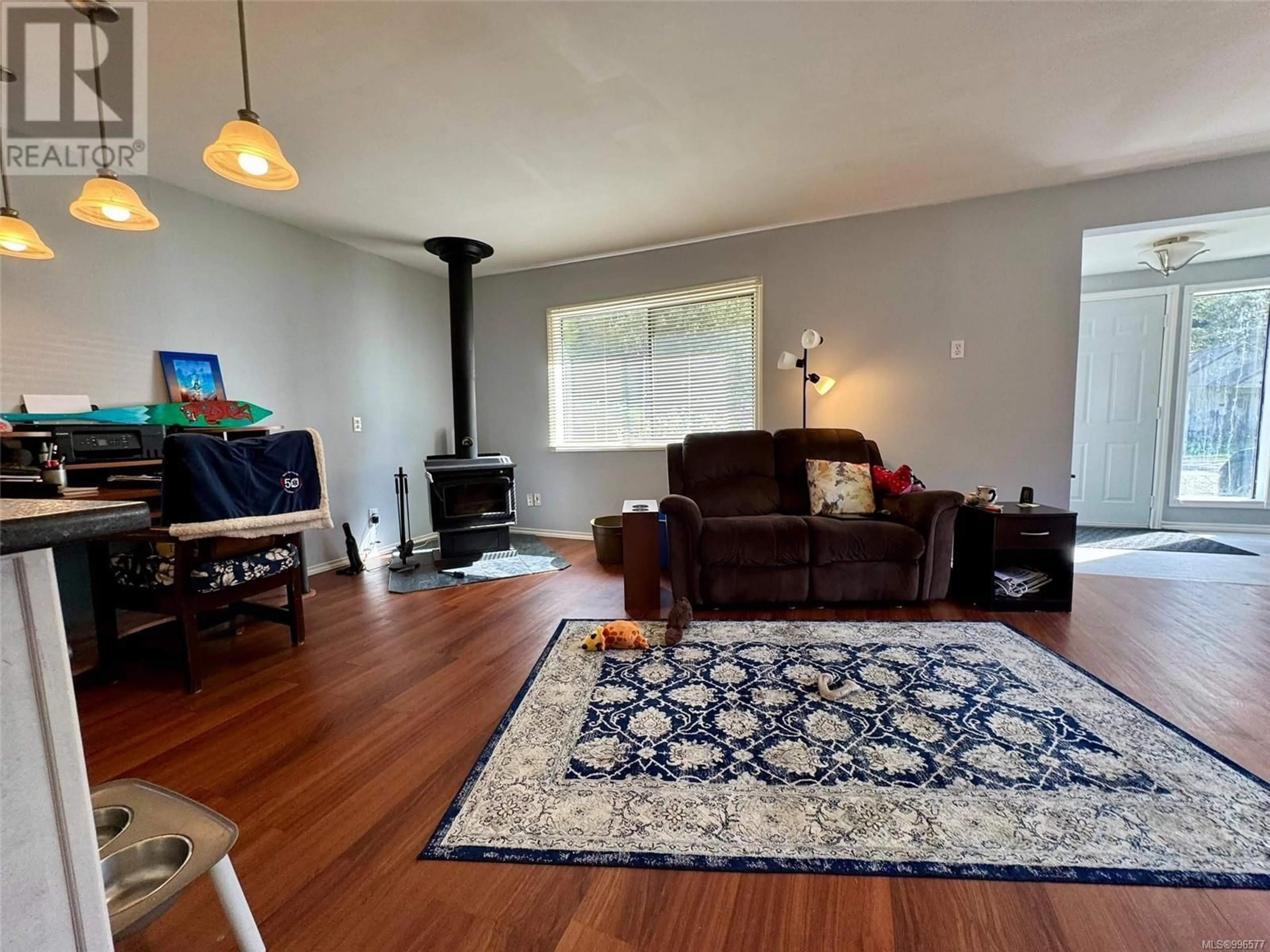 Living room with furniture, wood/laminate floor for 123 MAQUINNA AVENUE, Zeballos British Columbia V0P2A0