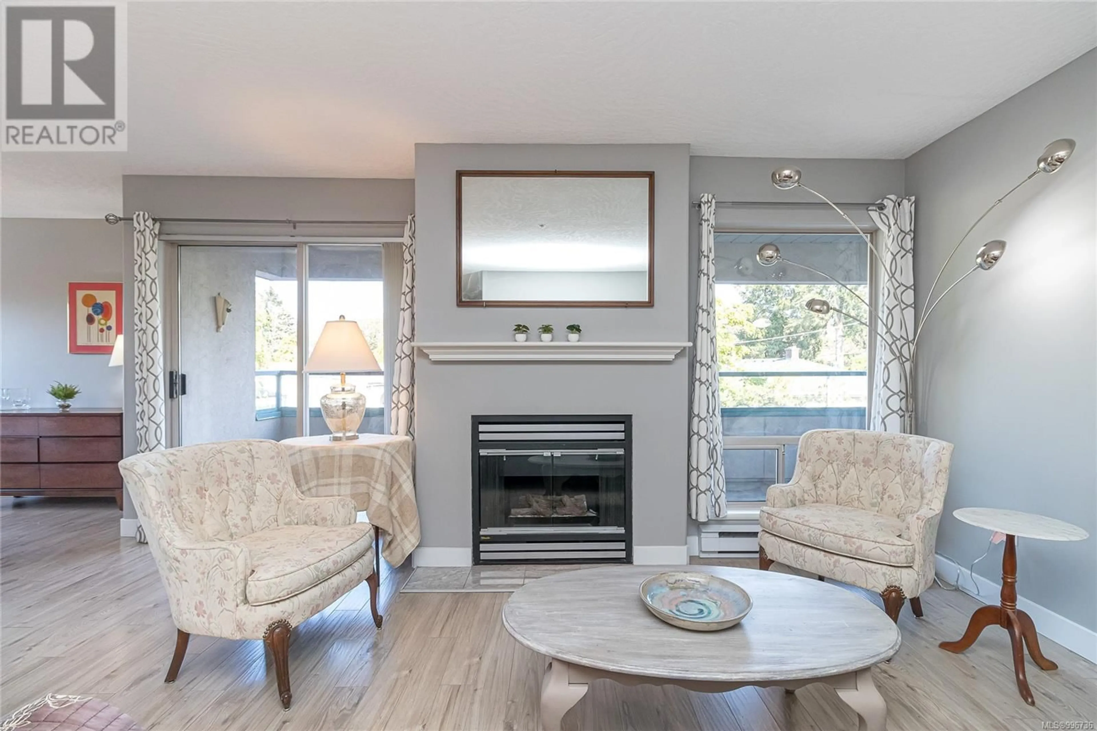 Living room with furniture, wood/laminate floor for 210 - 1100 UNION ROAD, Saanich British Columbia V8P2J3