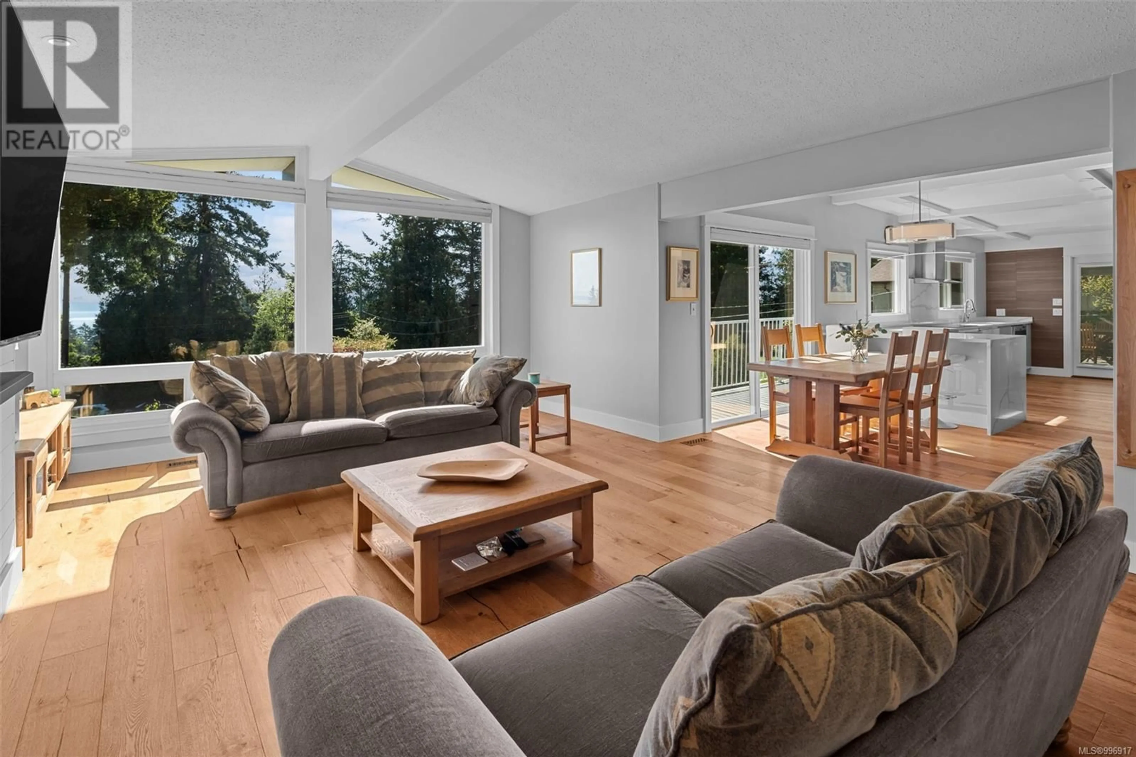Living room with furniture, wood/laminate floor for 8564 MOXON TERRACE, North Saanich British Columbia V8L1K6