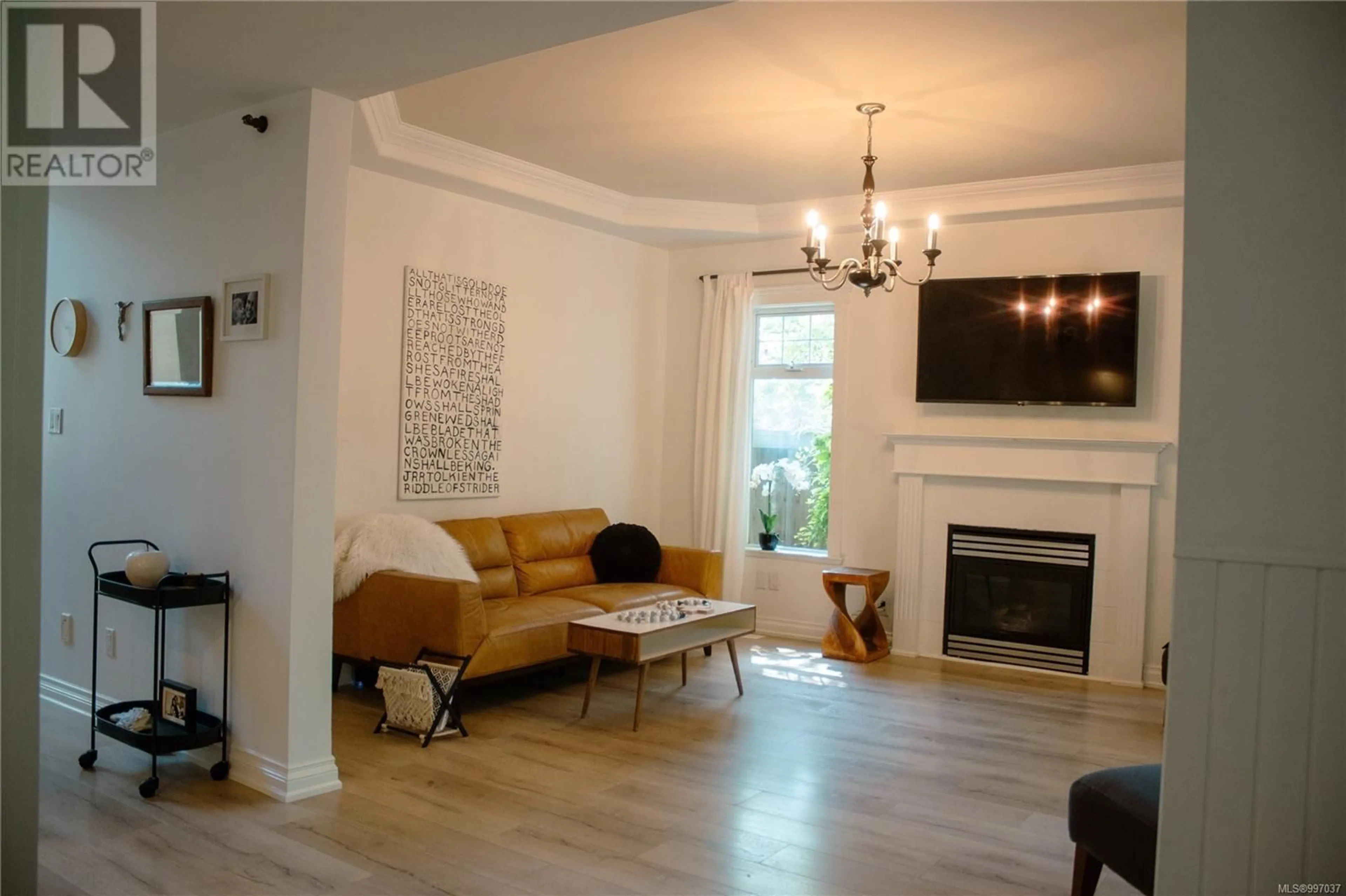 Living room with furniture, wood/laminate floor for 907 SAVARY DRIVE, Qualicum Beach British Columbia V9K1R7