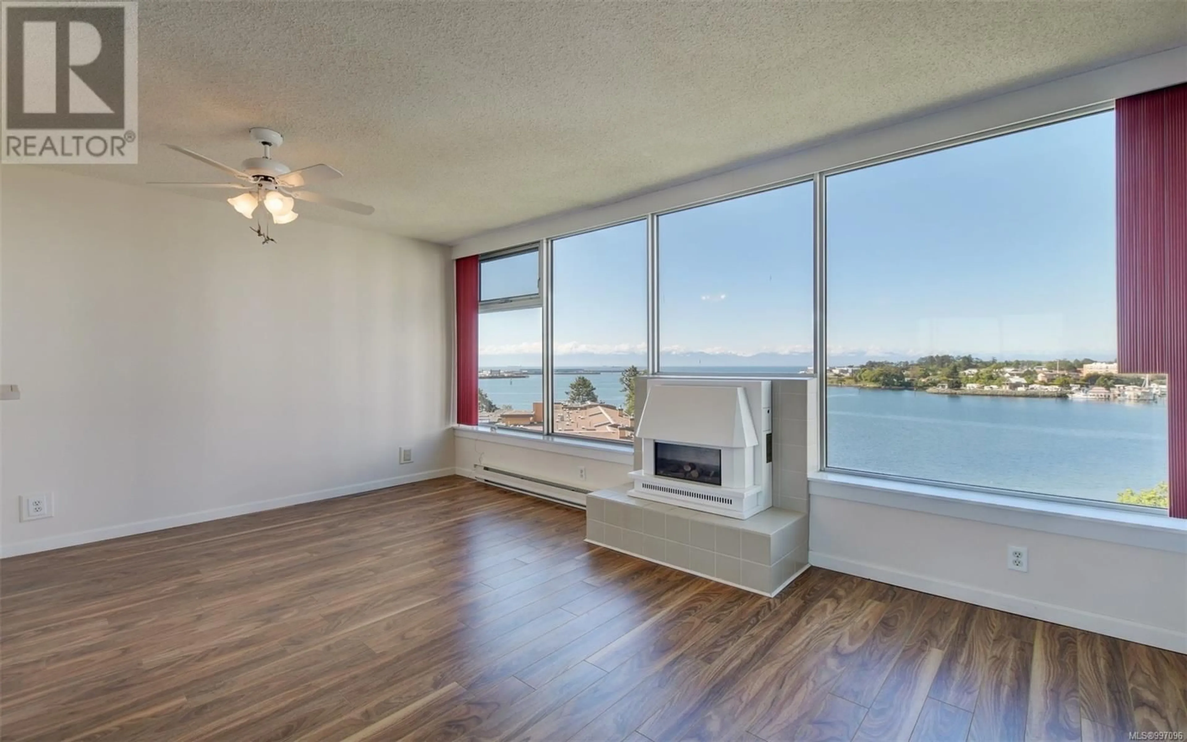 Living room with furniture, wood/laminate floor for 704 - 325 MAITLAND STREET, Victoria British Columbia V9A7E9