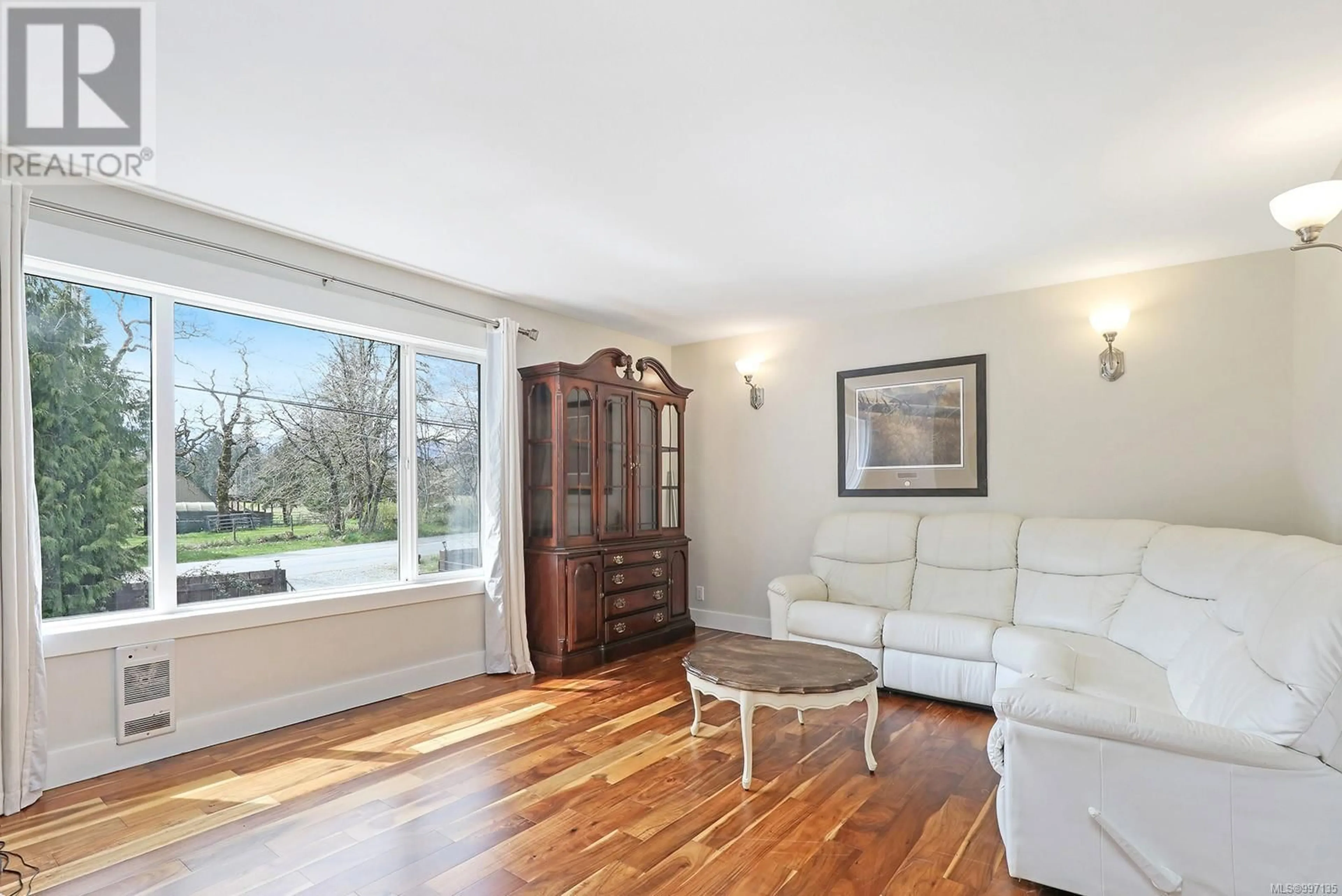 Living room with furniture, wood/laminate floor for 5252 HEADQUARTERS ROAD, Courtenay British Columbia V9N5M6