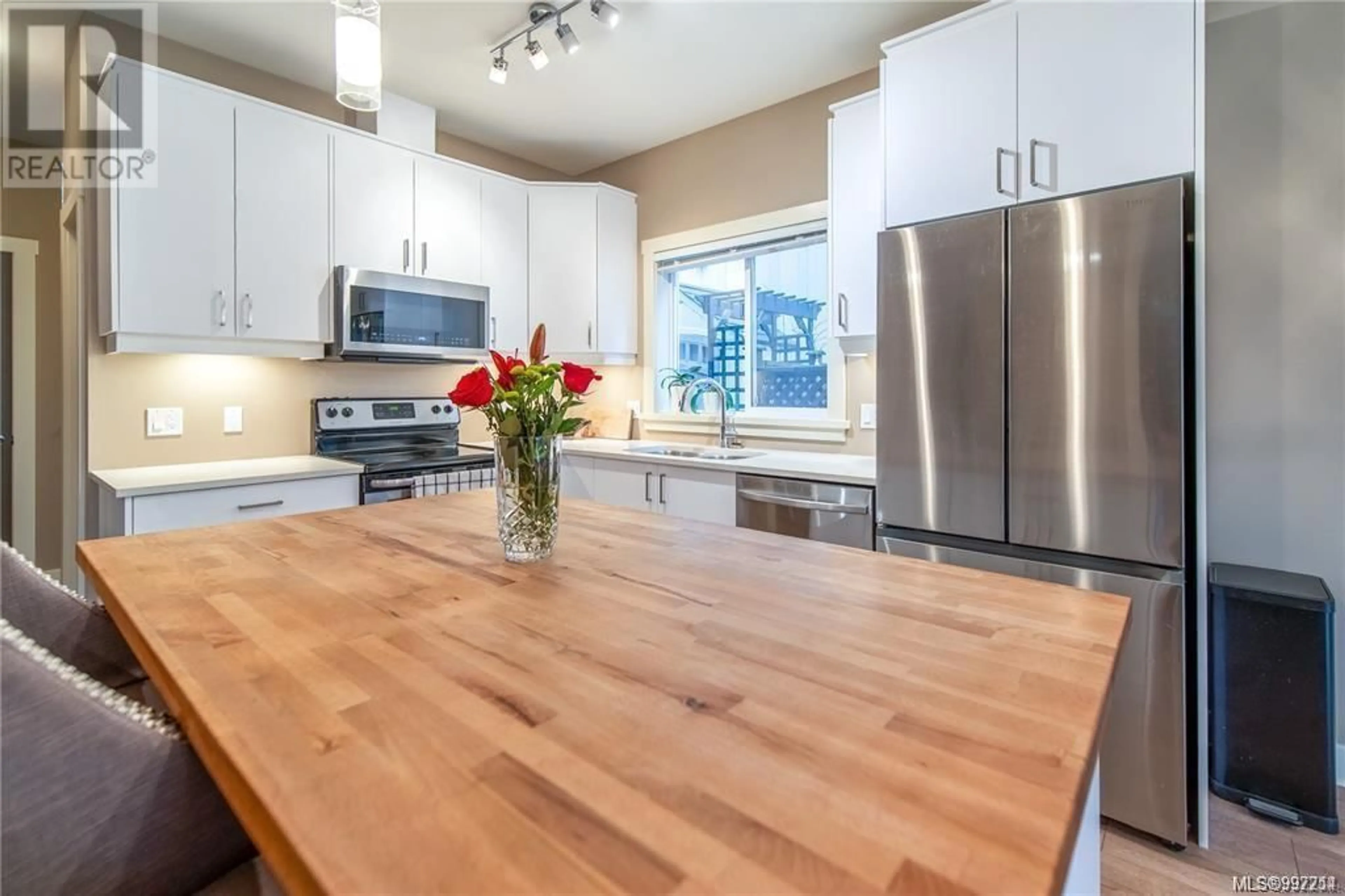 Open concept kitchen, wood/laminate floor for 1034 GALA COURT, Langford British Columbia V9C0J8
