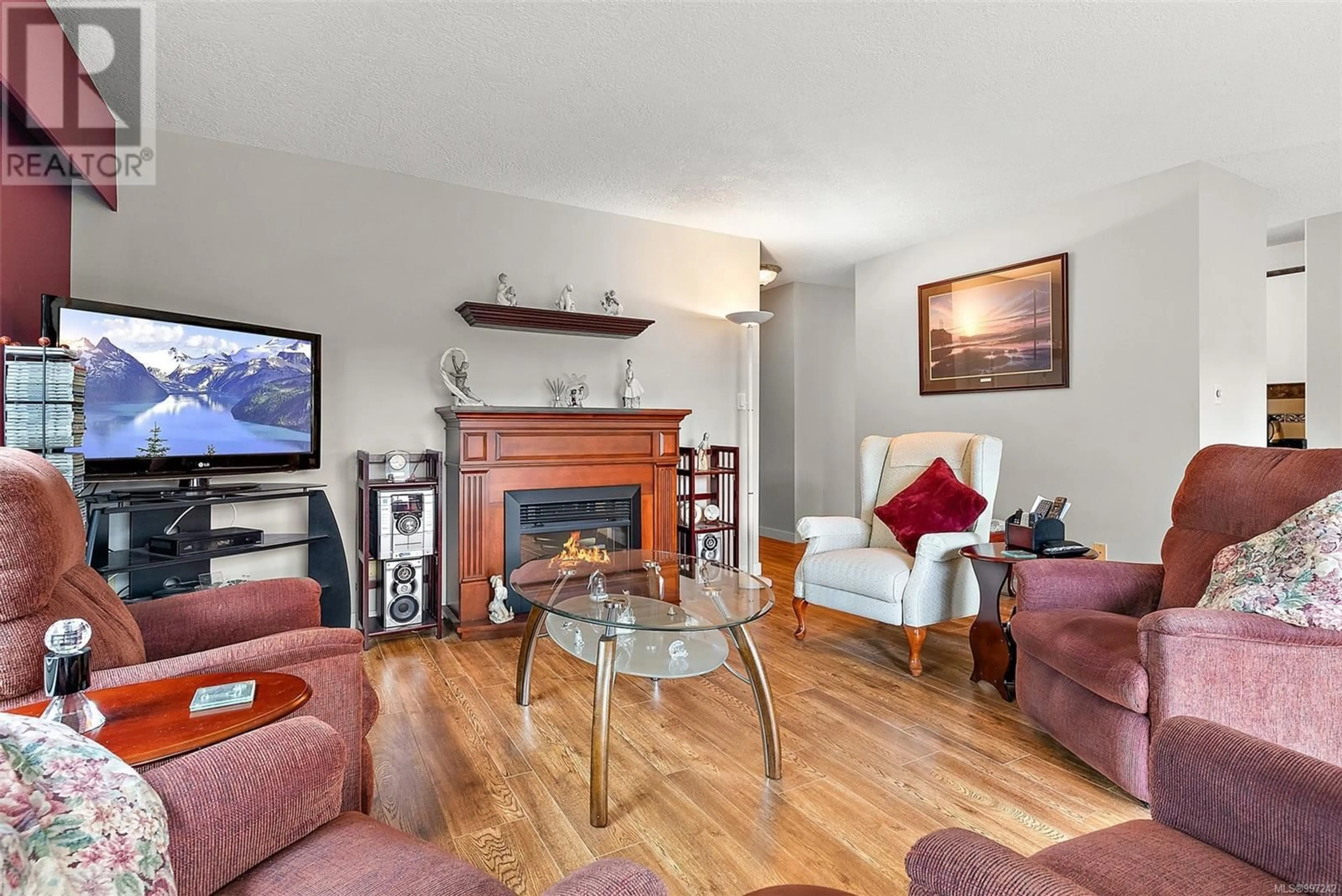 Living room with furniture, wood/laminate floor for 404 - 2920 COOK STREET, Victoria British Columbia V8T3S7