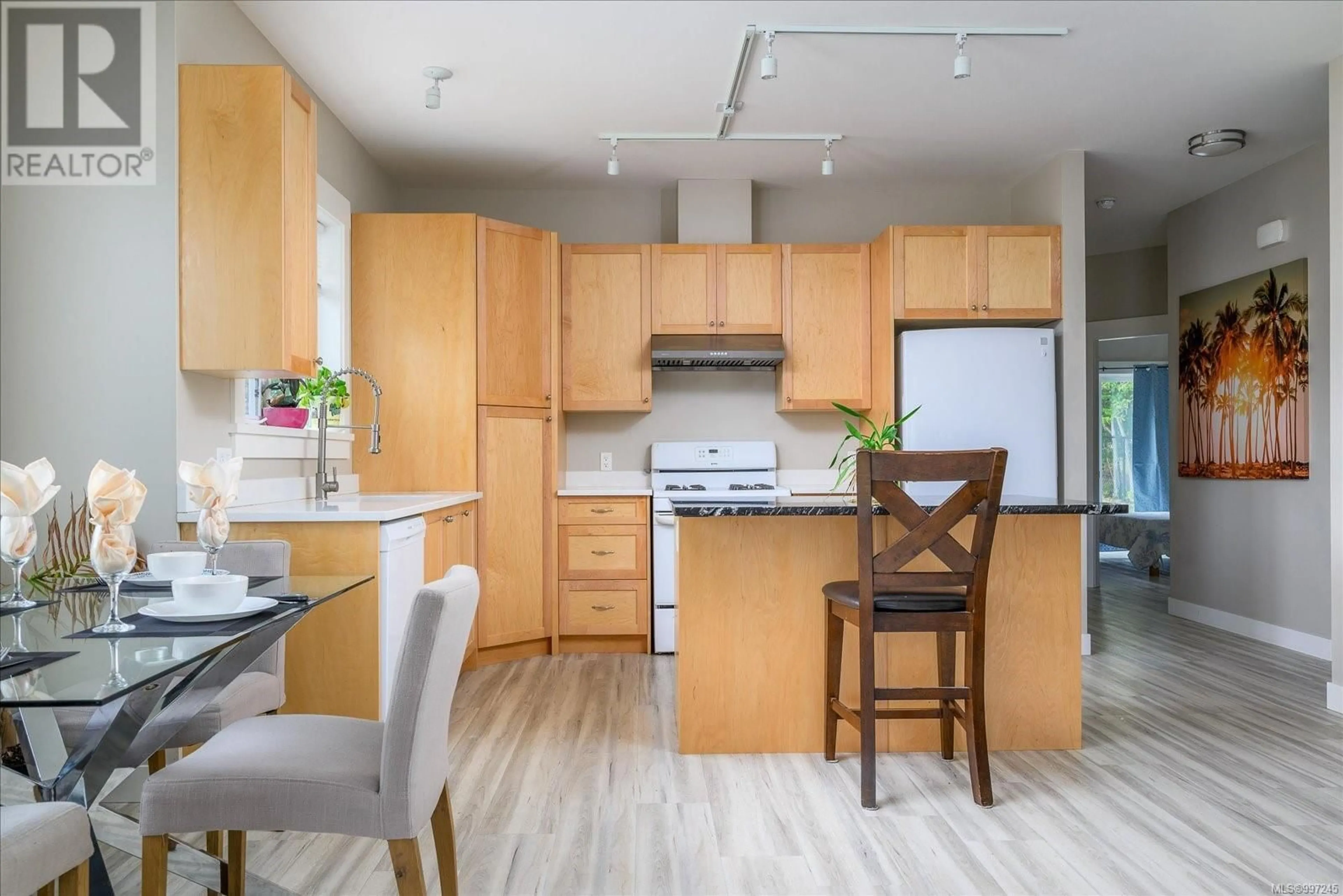 Open concept kitchen, wood/laminate floor for 104 LEE AVENUE, Parksville British Columbia V9P1L9