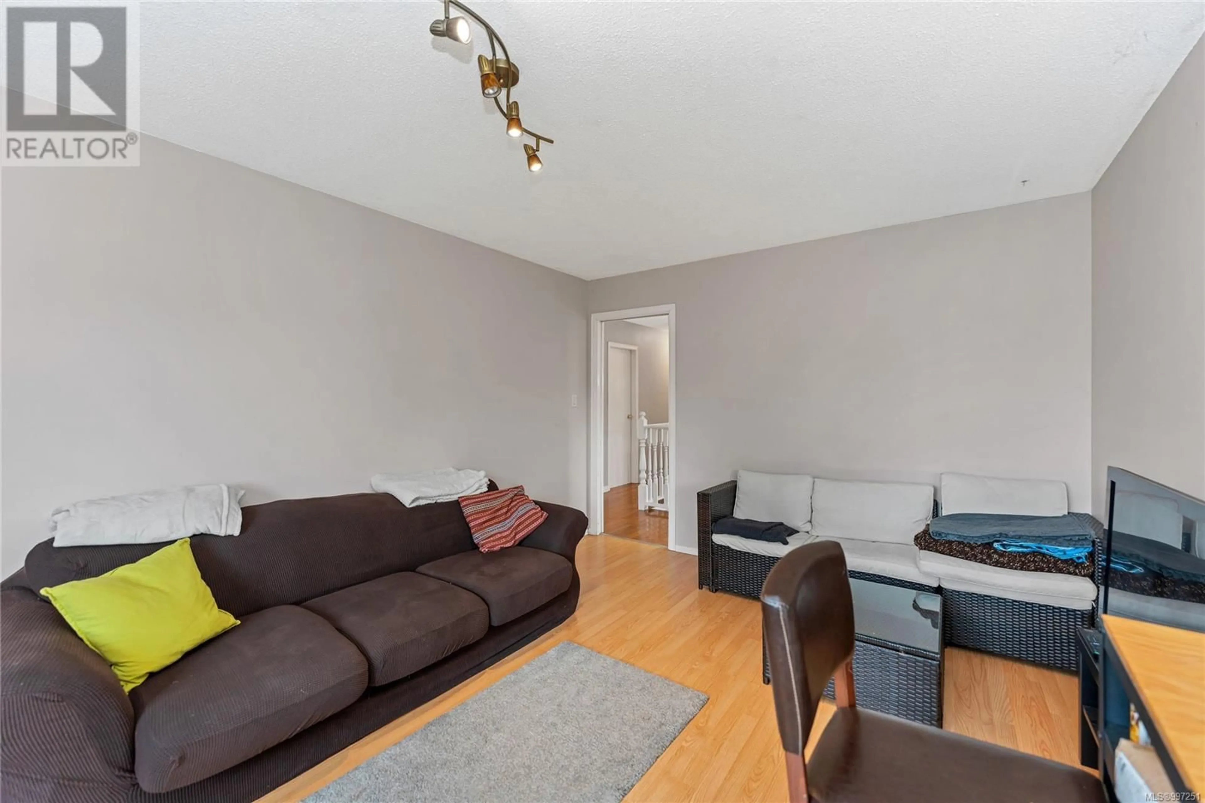 Living room with furniture, wood/laminate floor for 1560 PRAIRIE STREET, Saanich British Columbia V8N2L3