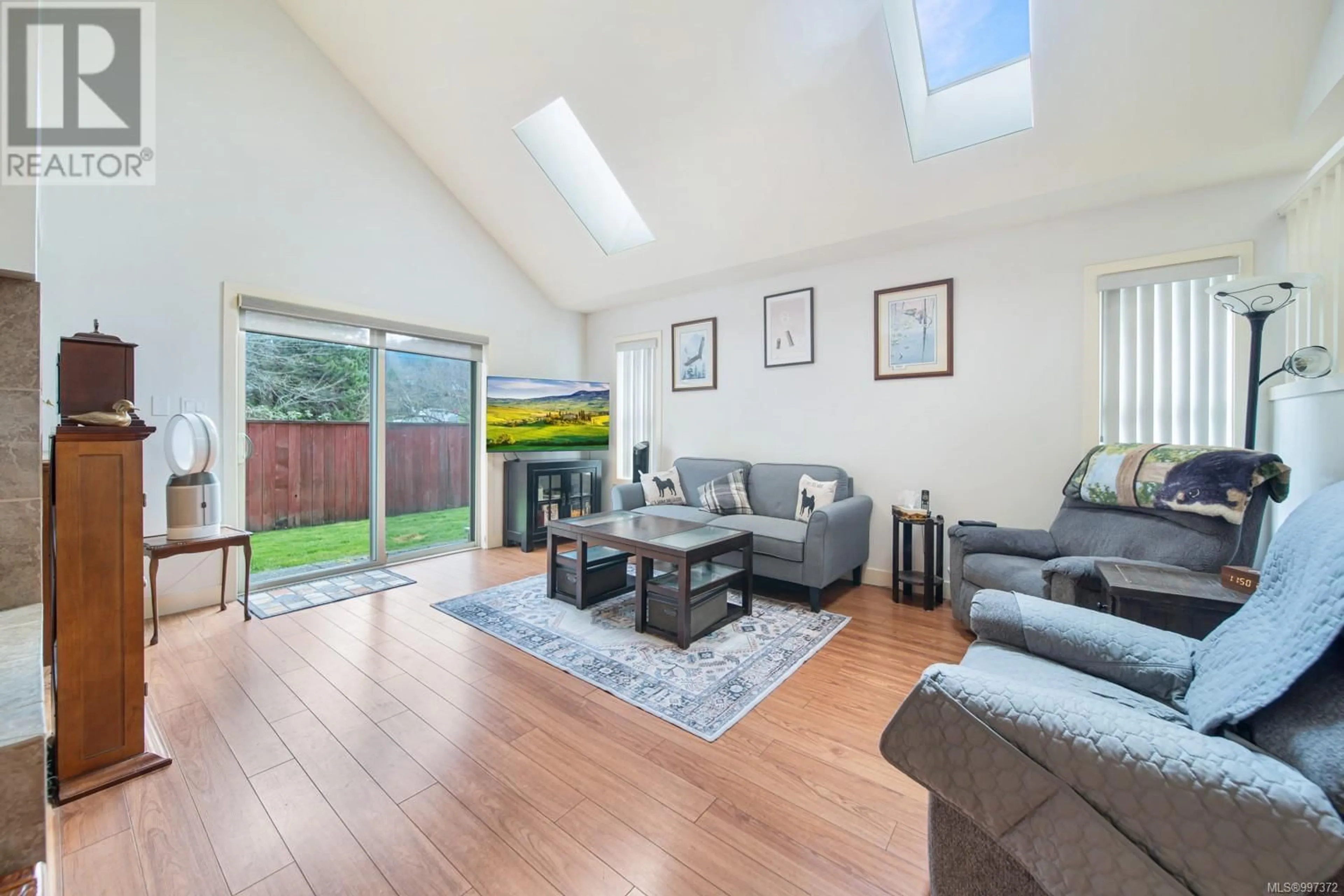 Living room with furniture, wood/laminate floor for 3221 ERNHILL PLACE, Langford British Columbia V9C0C6