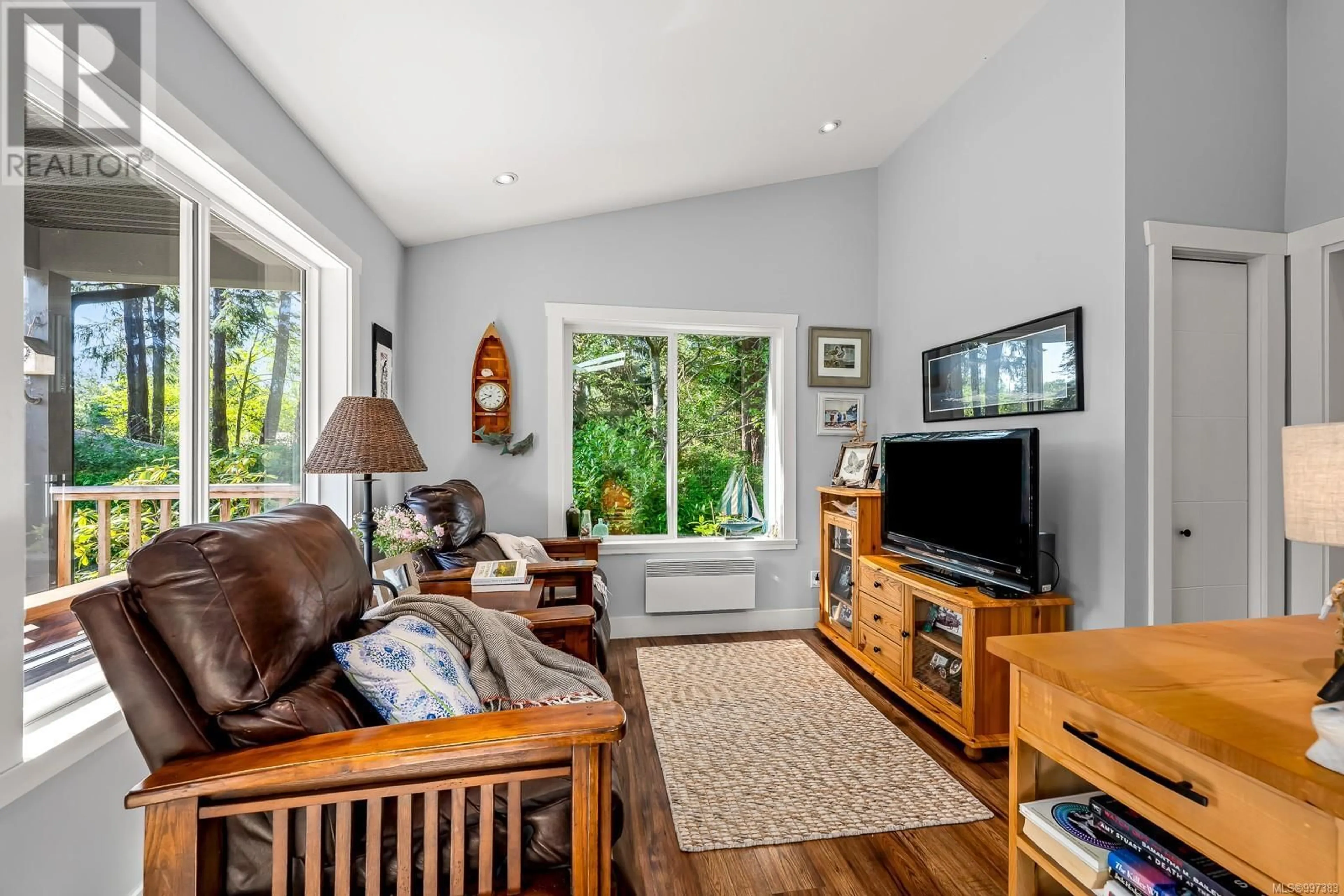 Living room with furniture, wood/laminate floor for 1495 BAIKIE ROAD, Denman Island British Columbia V0R1T0