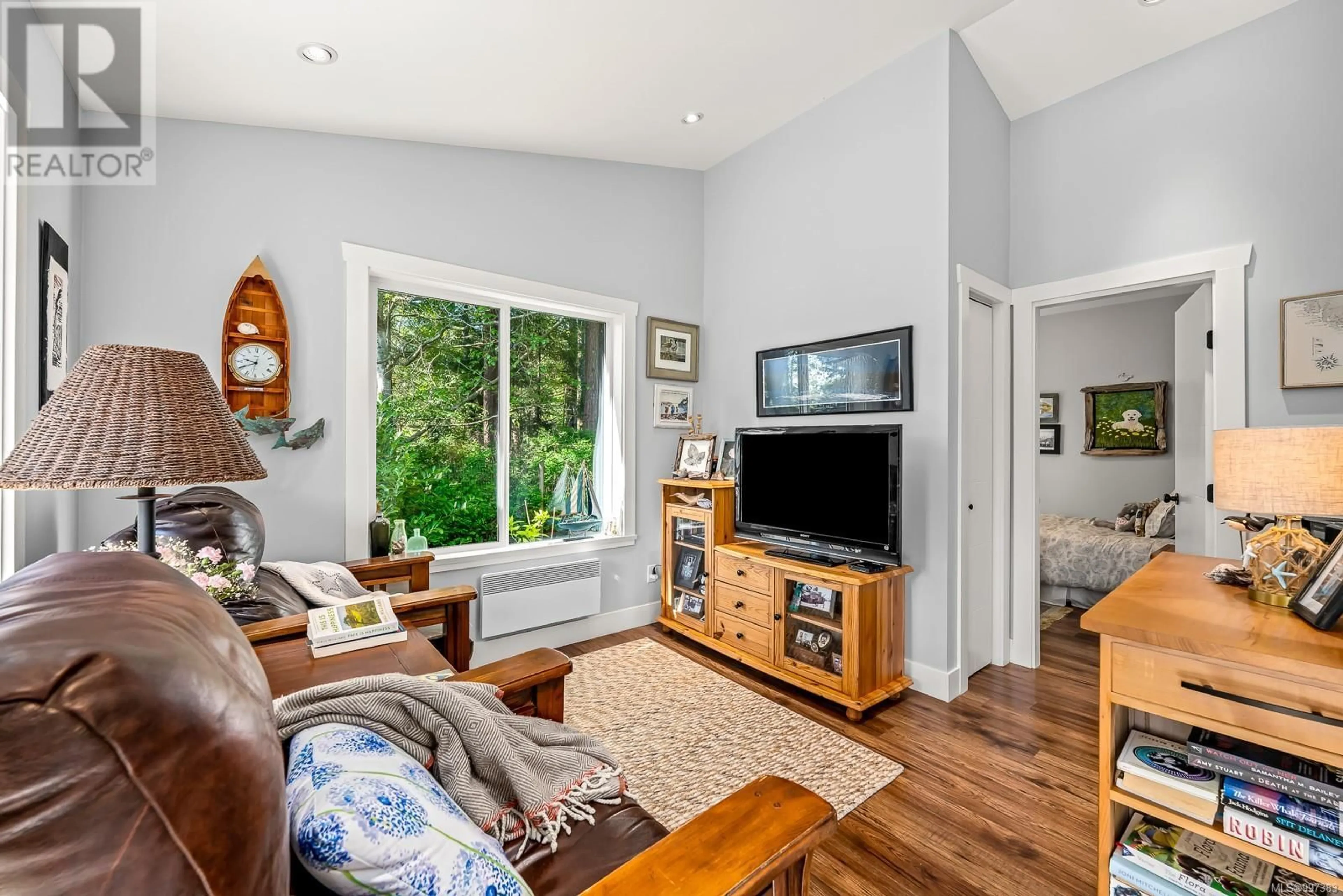 Living room with furniture, wood/laminate floor for 1495 BAIKIE ROAD, Denman Island British Columbia V0R1T0