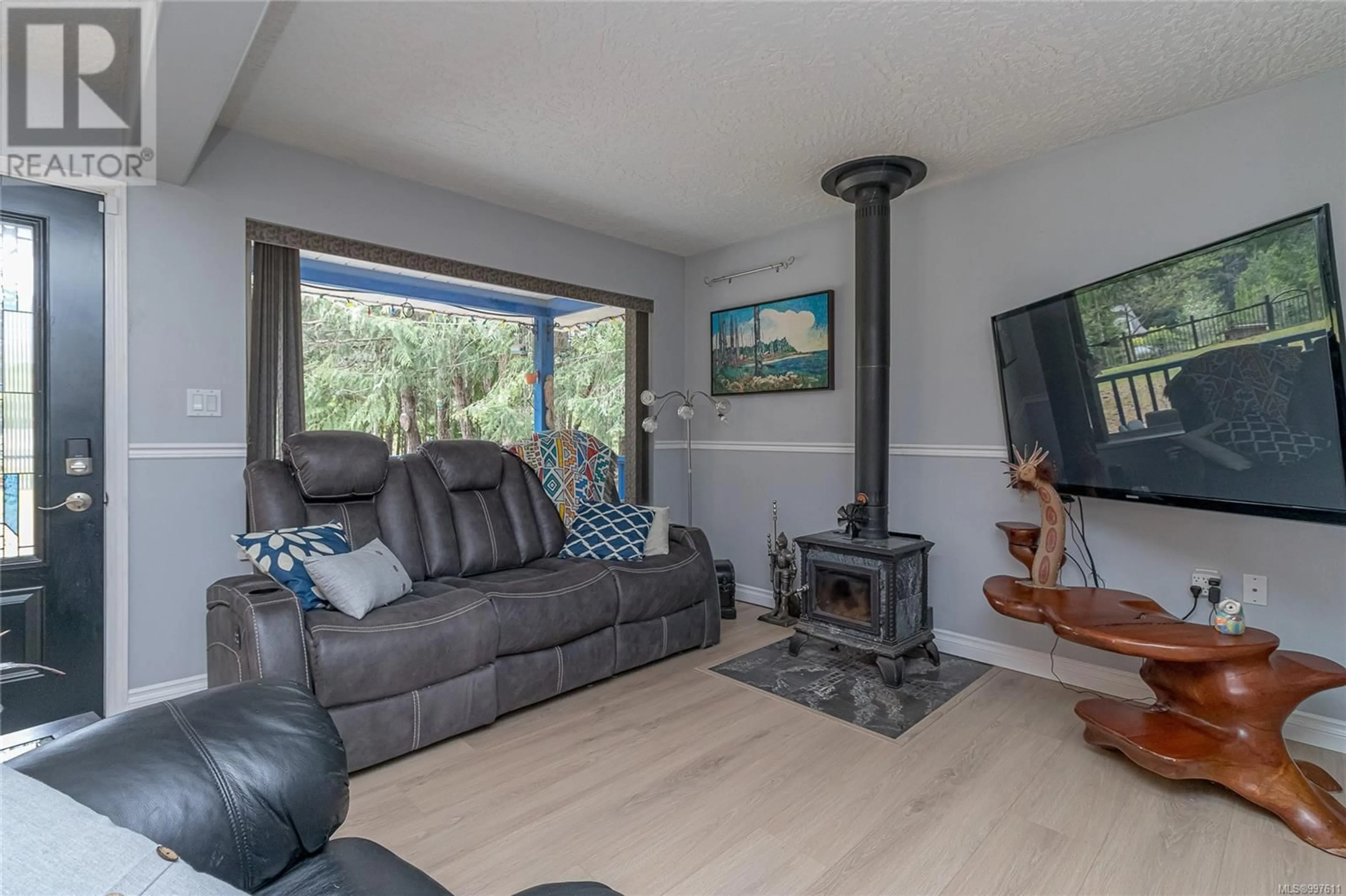 Living room with furniture, wood/laminate floor for 1335 MEADOWOOD WAY, Qualicum Beach British Columbia V9K2S4