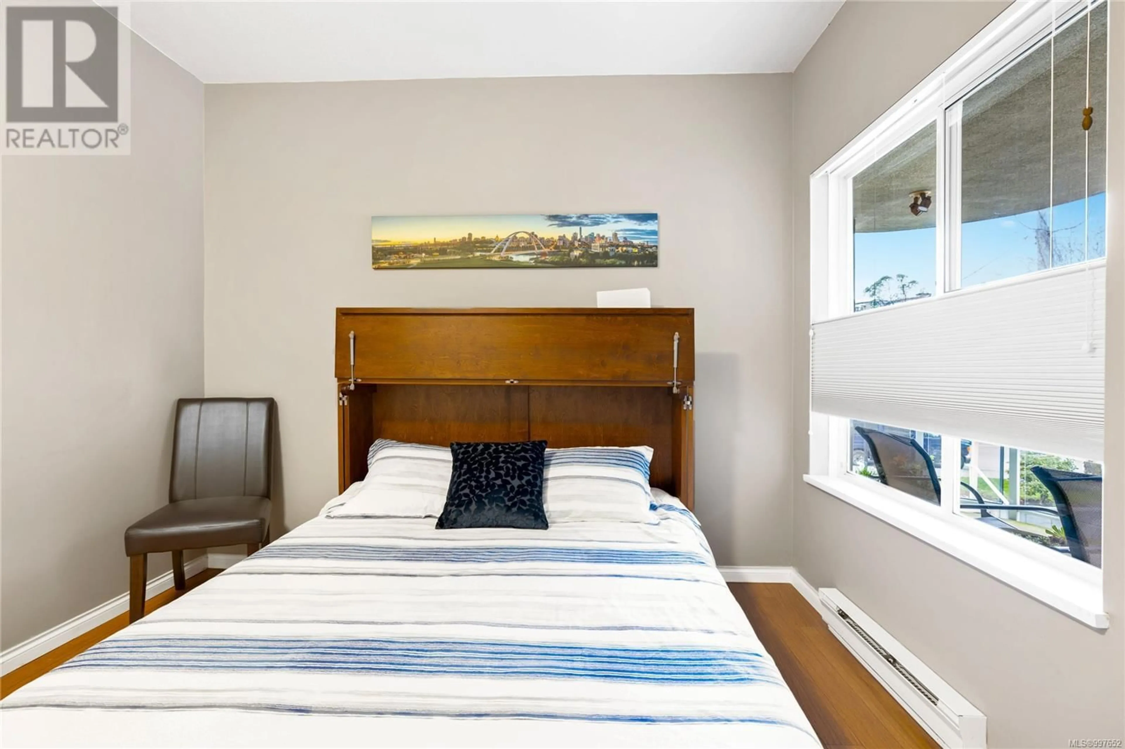 Bedroom with bed, wood/laminate floor for 302 - 560 STEWART AVENUE, Nanaimo British Columbia V9S5T5