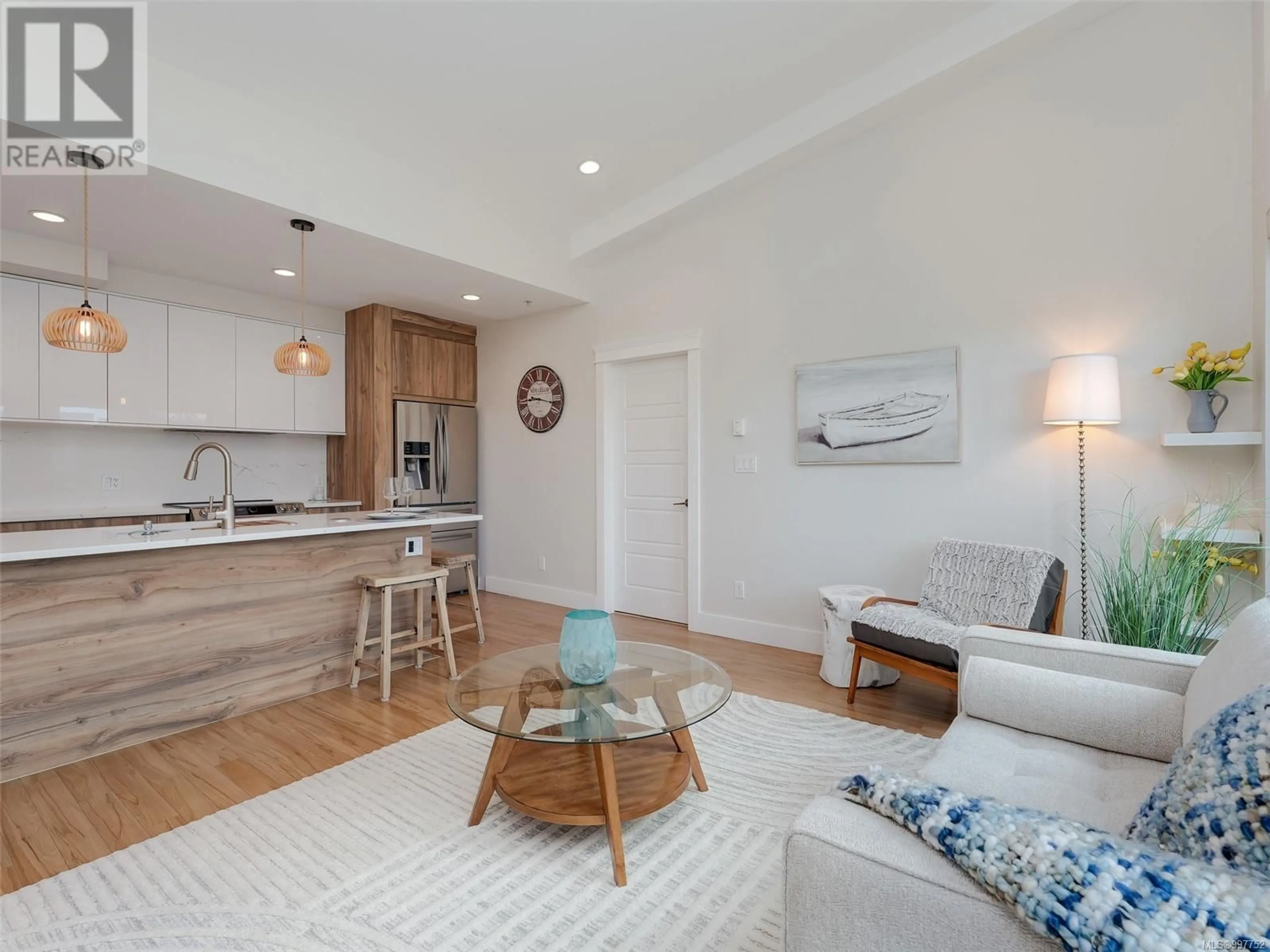 Living room with furniture, wood/laminate floor for 403 - 7161 WEST SAANICH ROAD, Central Saanich British Columbia V8M1P7