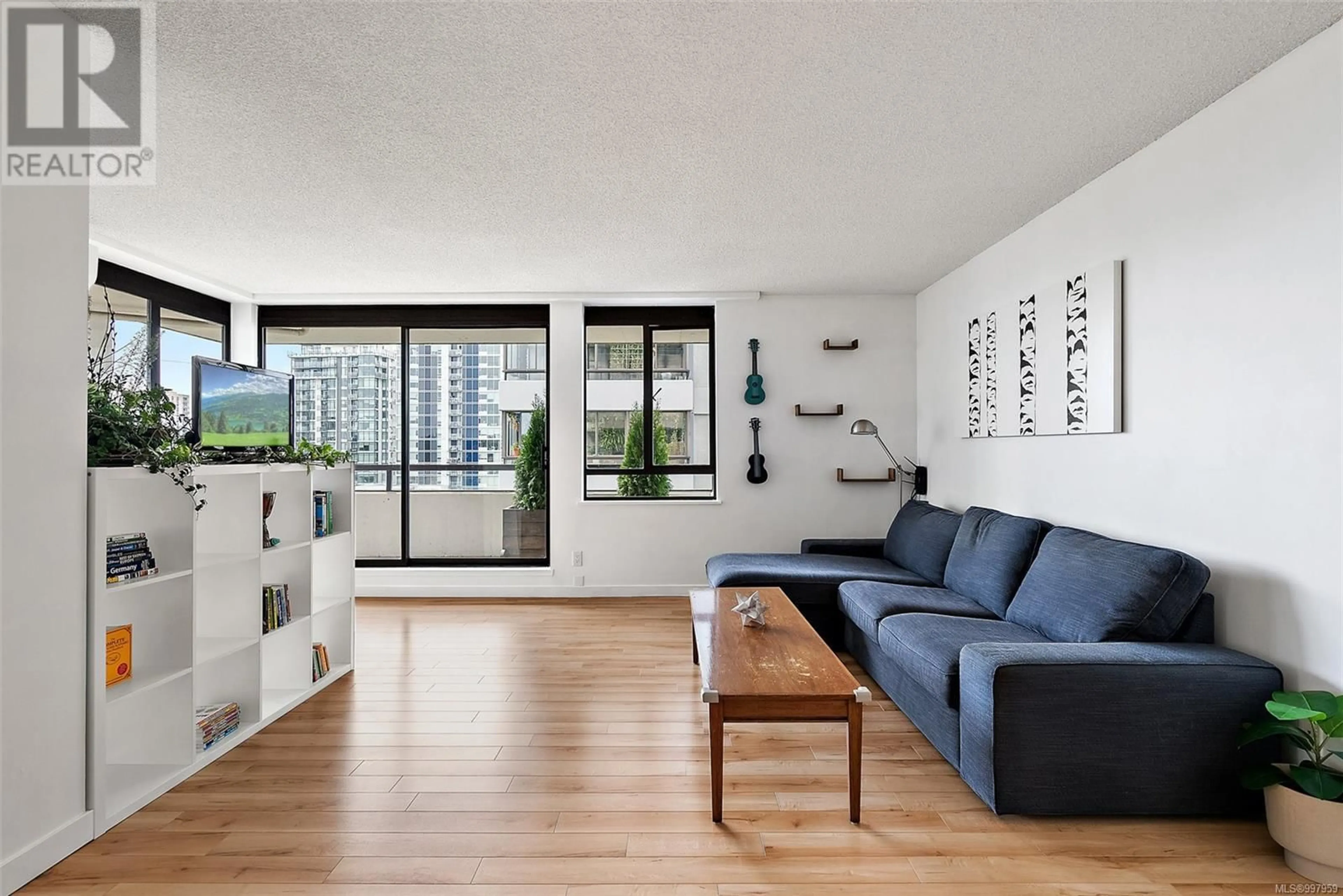Living room with furniture, wood/laminate floor for 702 - 1034 JOHNSON STREET, Victoria British Columbia V8V3N7