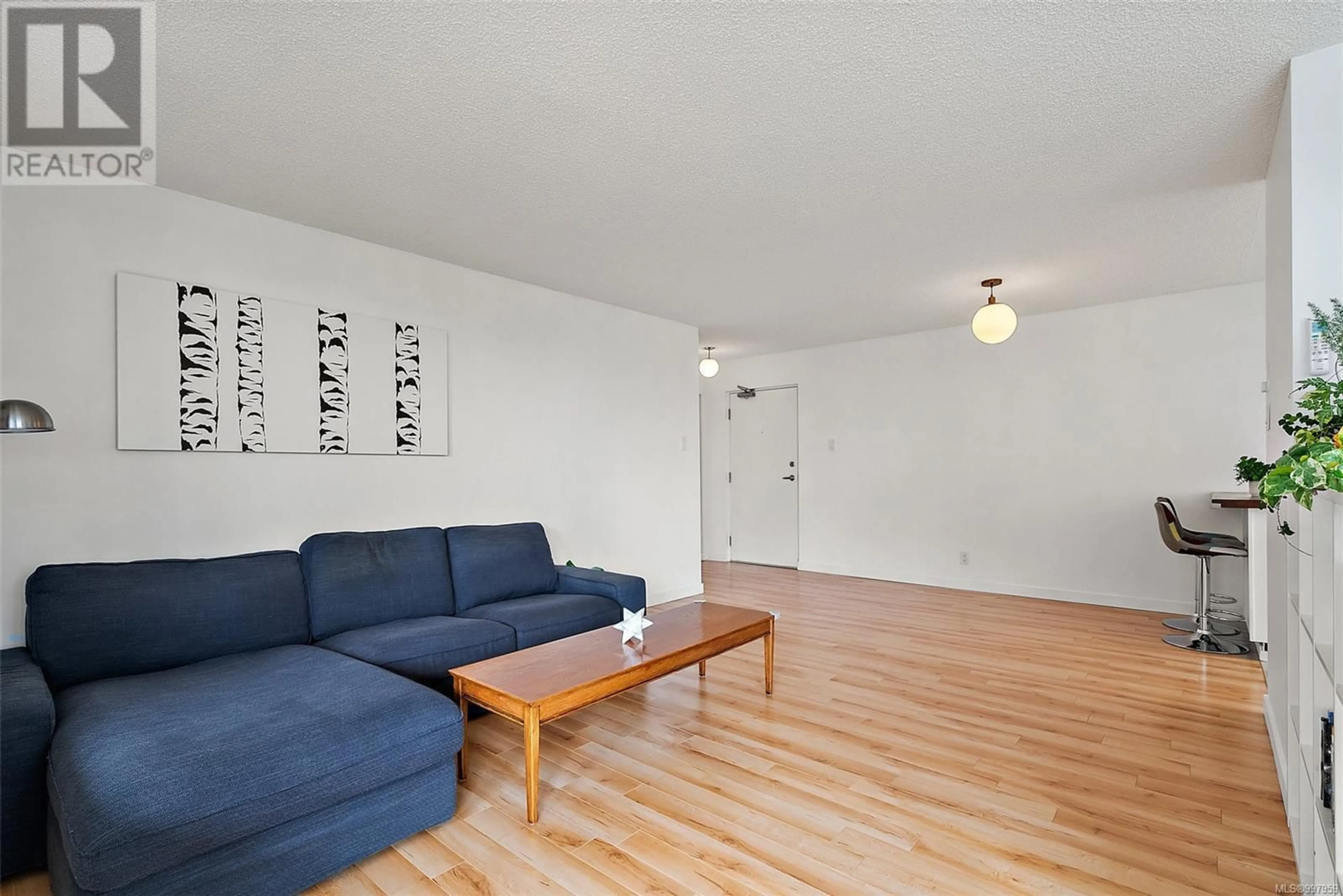 Living room with furniture, wood/laminate floor for 702 - 1034 JOHNSON STREET, Victoria British Columbia V8V3N7