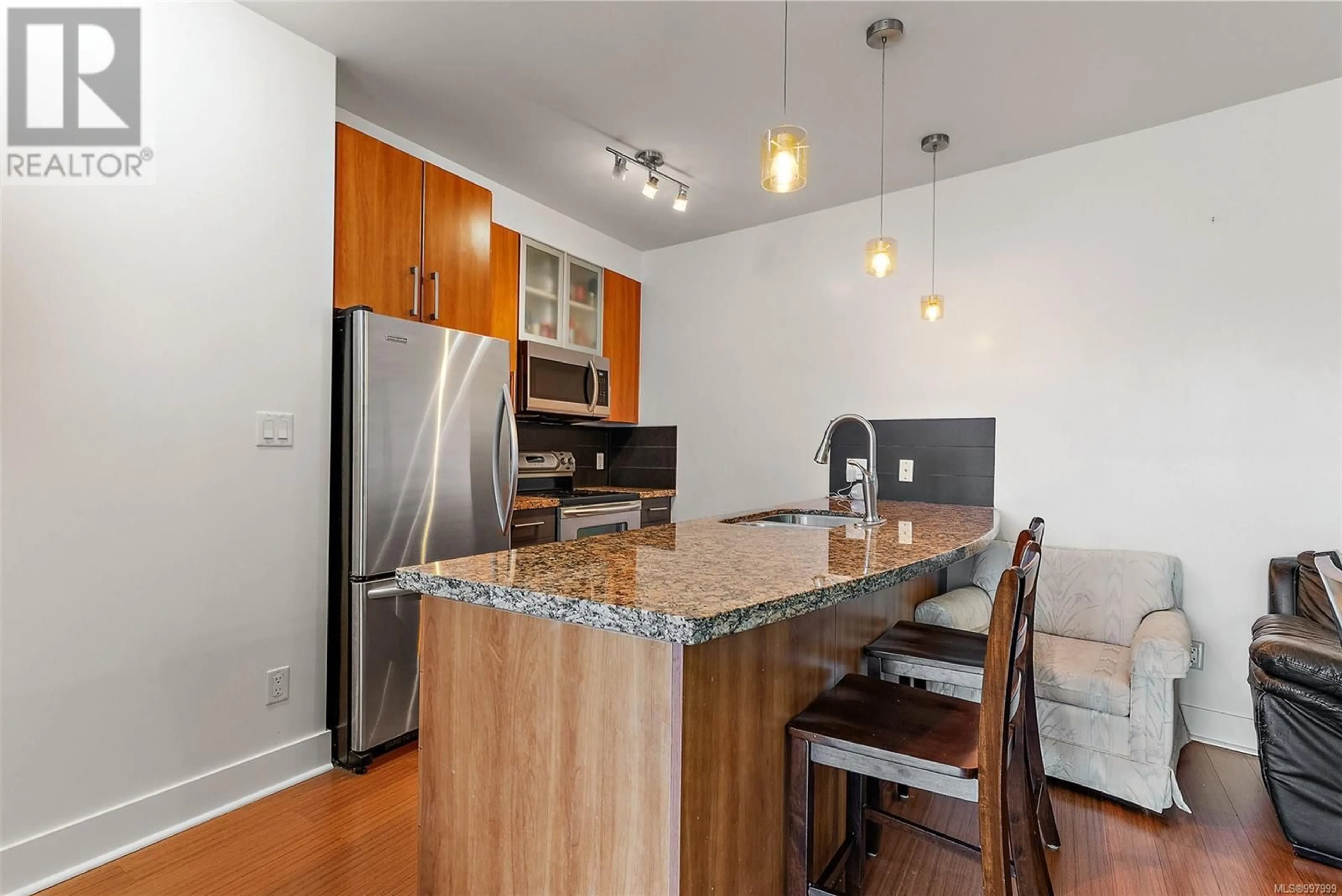 Open concept kitchen, wood/laminate floor for 409 - 2745 VETERANS MEMORIAL PARKWAY, Langford British Columbia V9B0H4