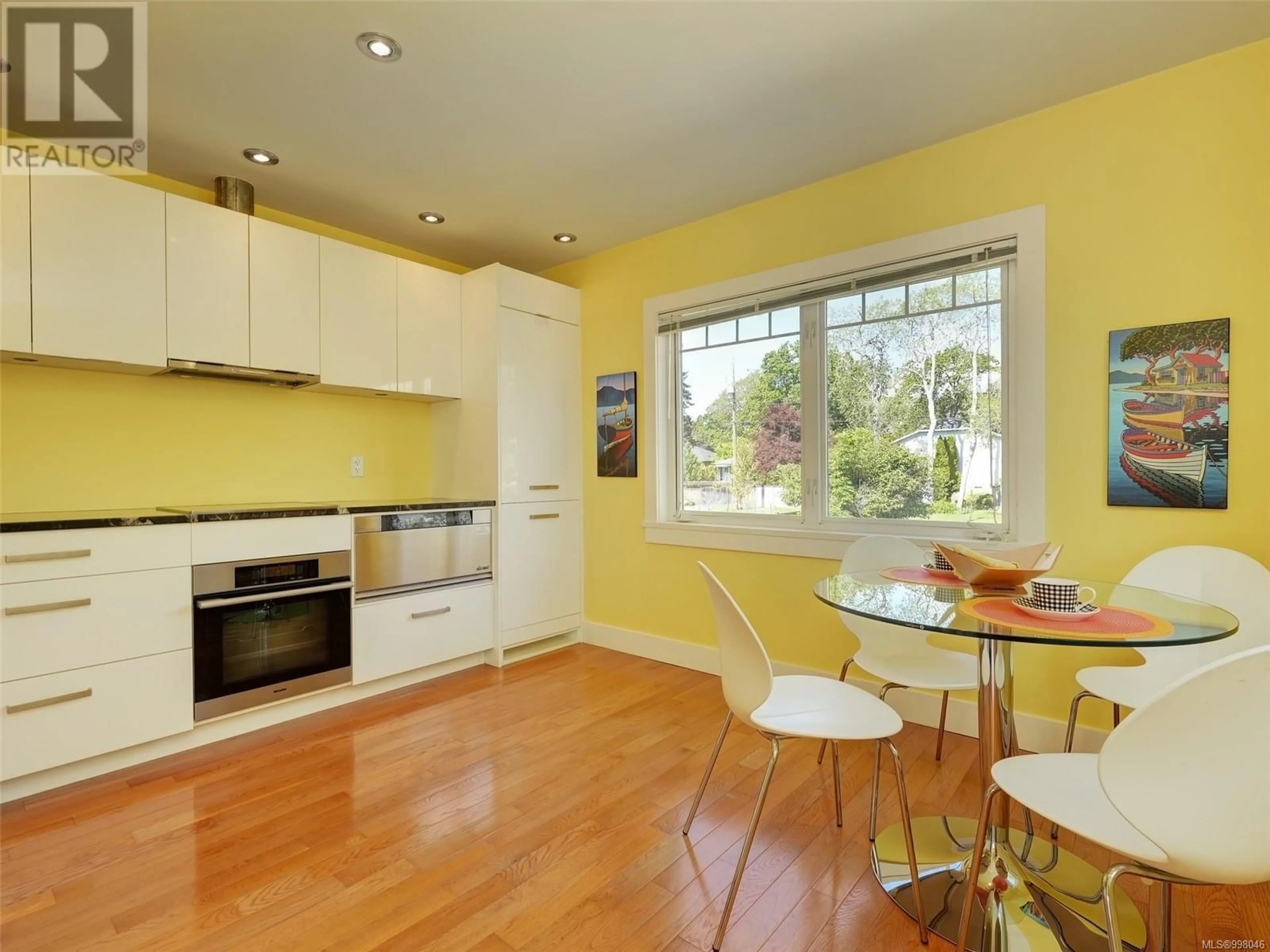 Open concept kitchen, wood/laminate floor for 1865 QUAMICHAN STREET, Victoria British Columbia V8S2B7