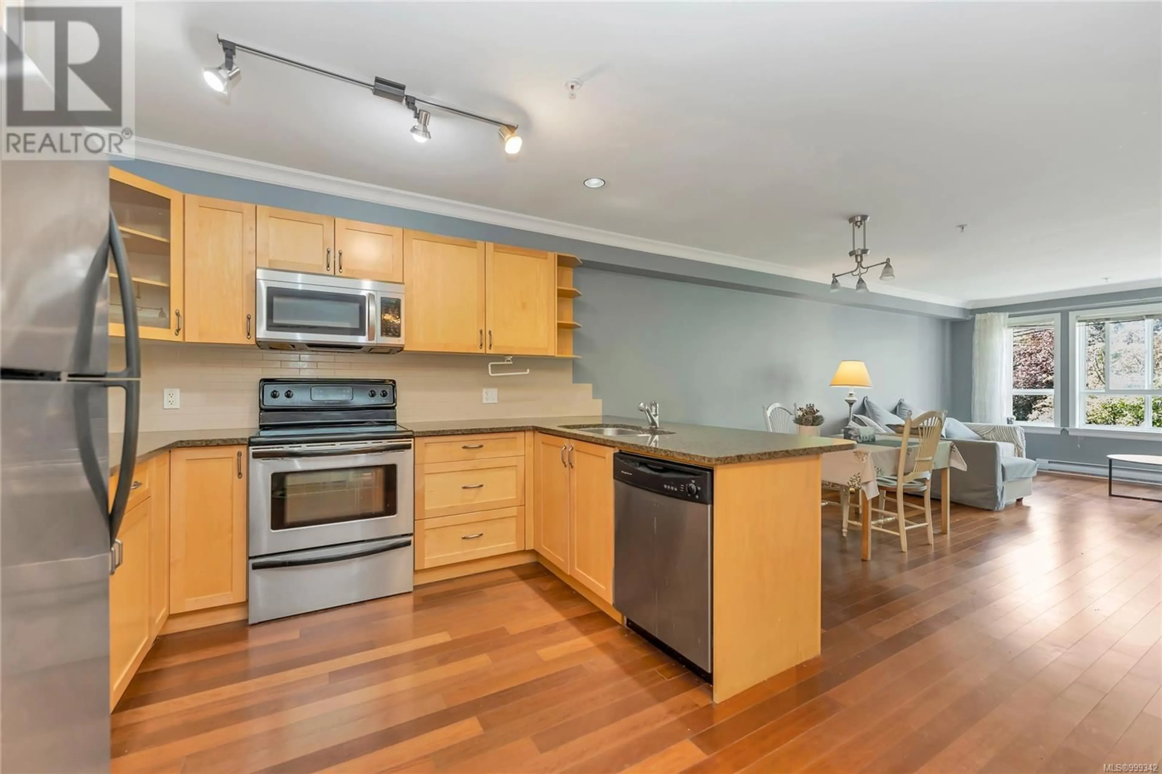 Open concept kitchen, wood/laminate floor for 203 - 1514 CHURCH AVENUE, Saanich British Columbia V8P0A3