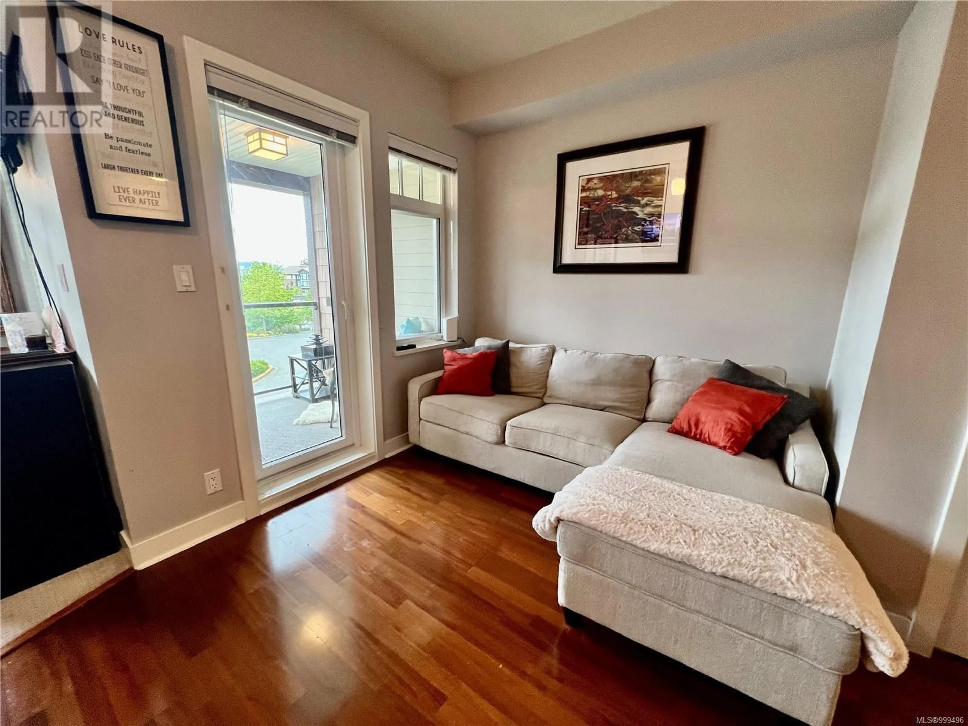 Living room with furniture, wood/laminate floor for 219 - 1395 BEAR MOUNTAIN PARKWAY, Langford British Columbia V9B0E1