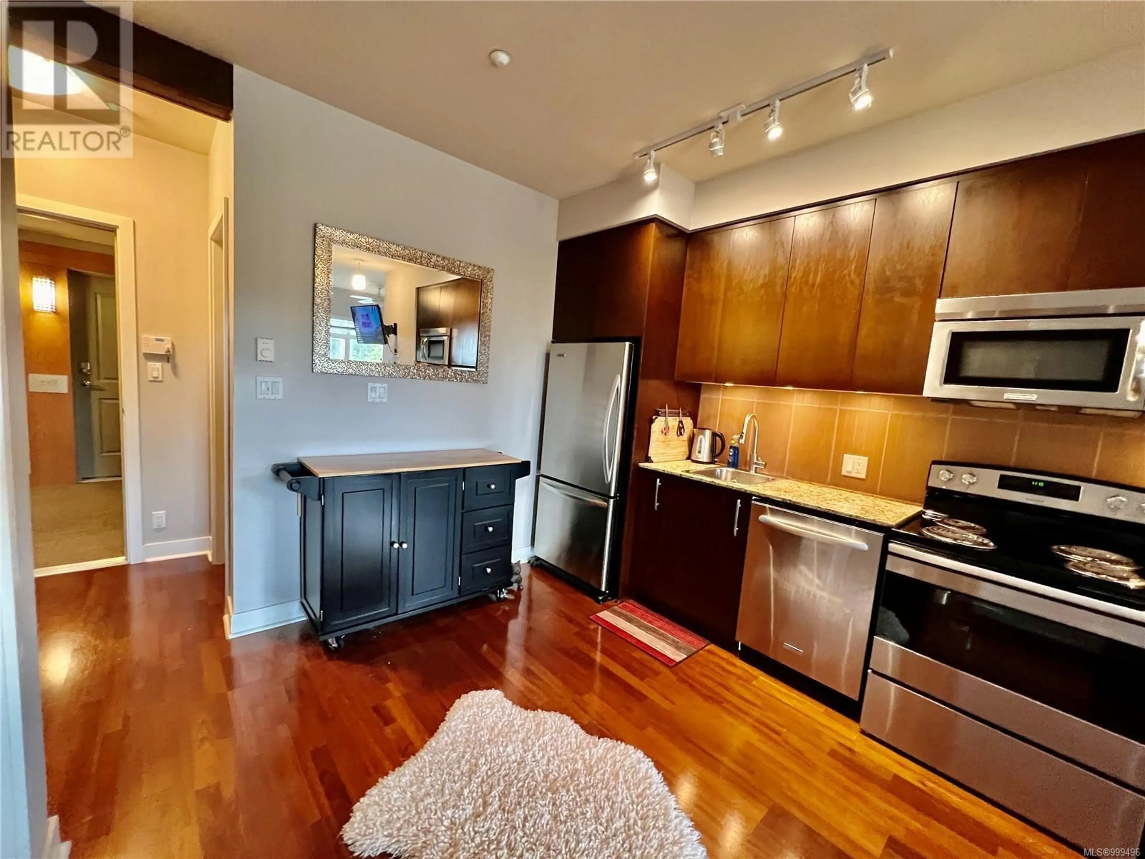 Open concept kitchen, wood/laminate floor for 219 - 1395 BEAR MOUNTAIN PARKWAY, Langford British Columbia V9B0E1