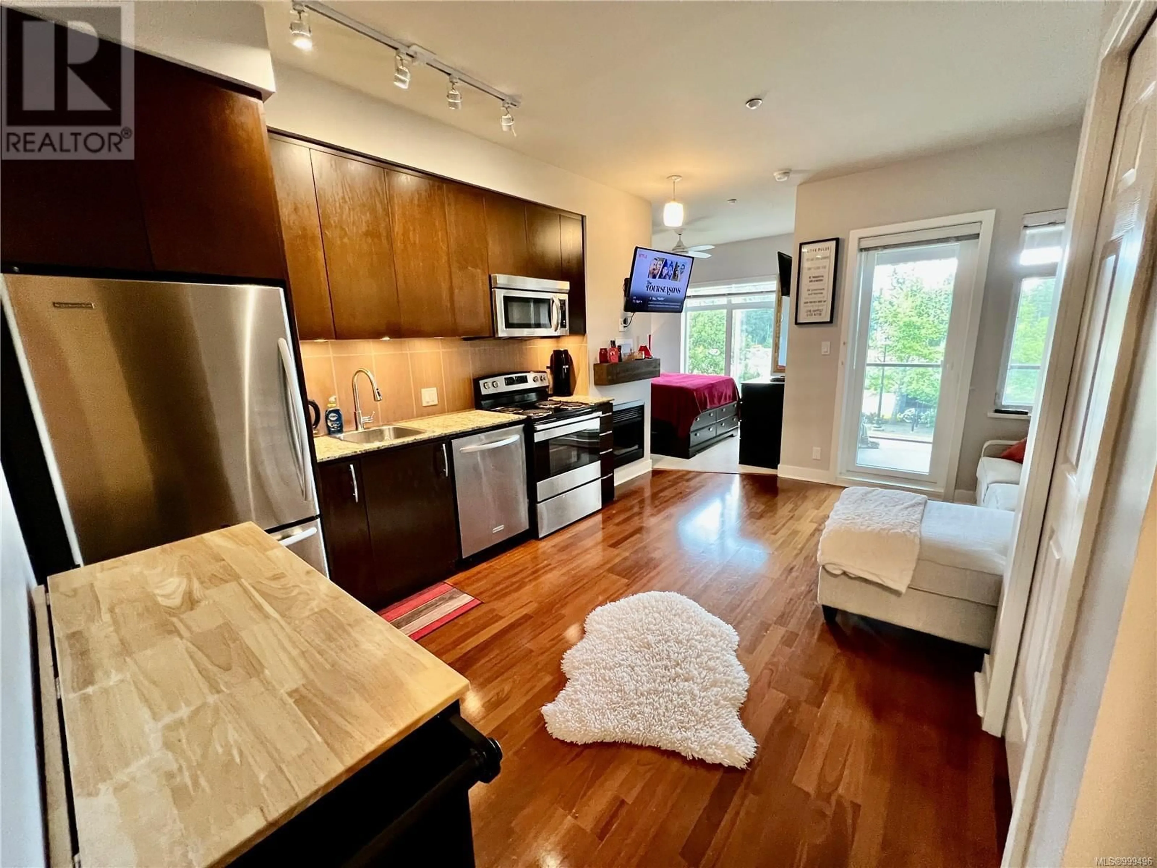 Open concept kitchen, wood/laminate floor for 219 - 1395 BEAR MOUNTAIN PARKWAY, Langford British Columbia V9B0E1