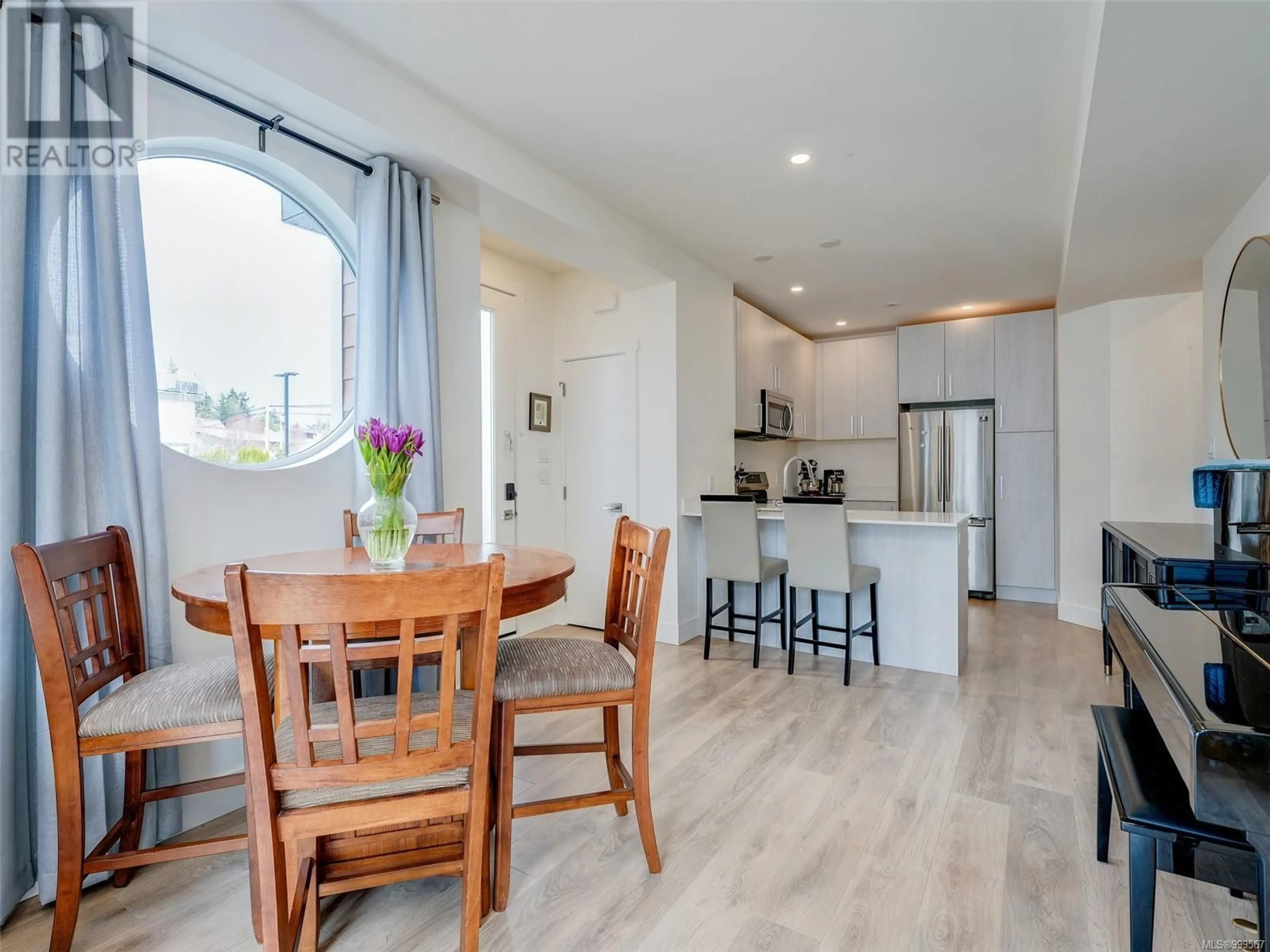 Open concept kitchen, wood/laminate floor for 101 - 3331 RADIANT WAY, Langford British Columbia V9C0K3
