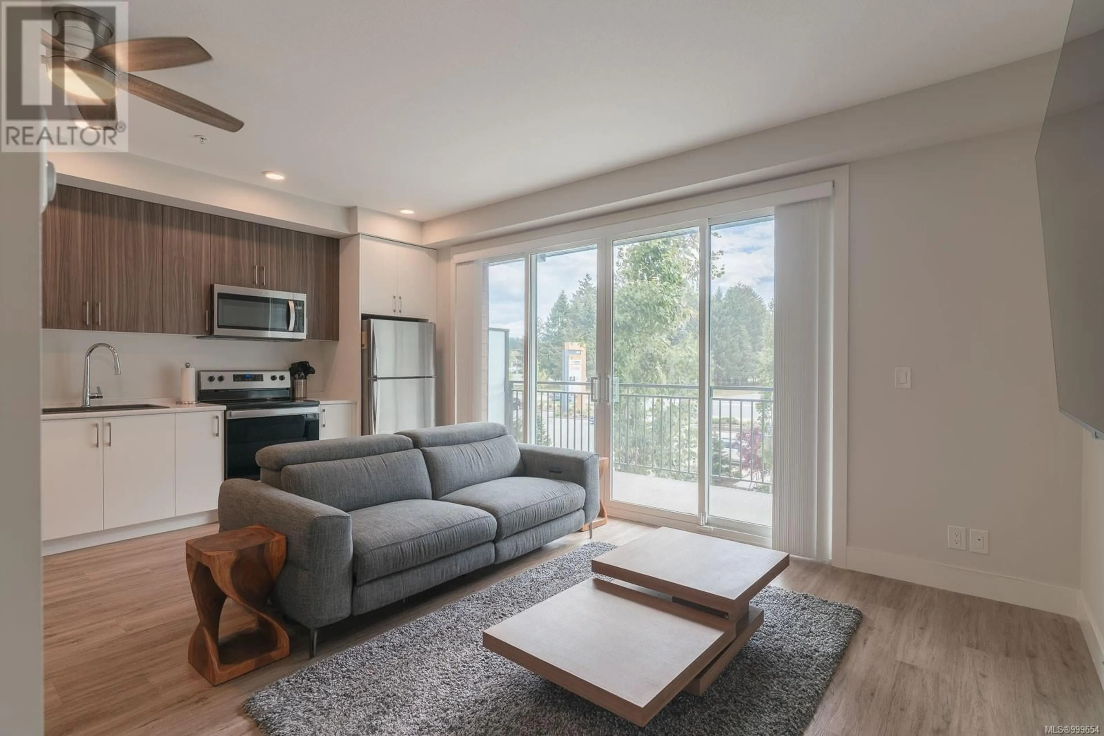 Living room with furniture, wood/laminate floor for 306 - 6544 METRAL DRIVE, Nanaimo British Columbia V9T2L8