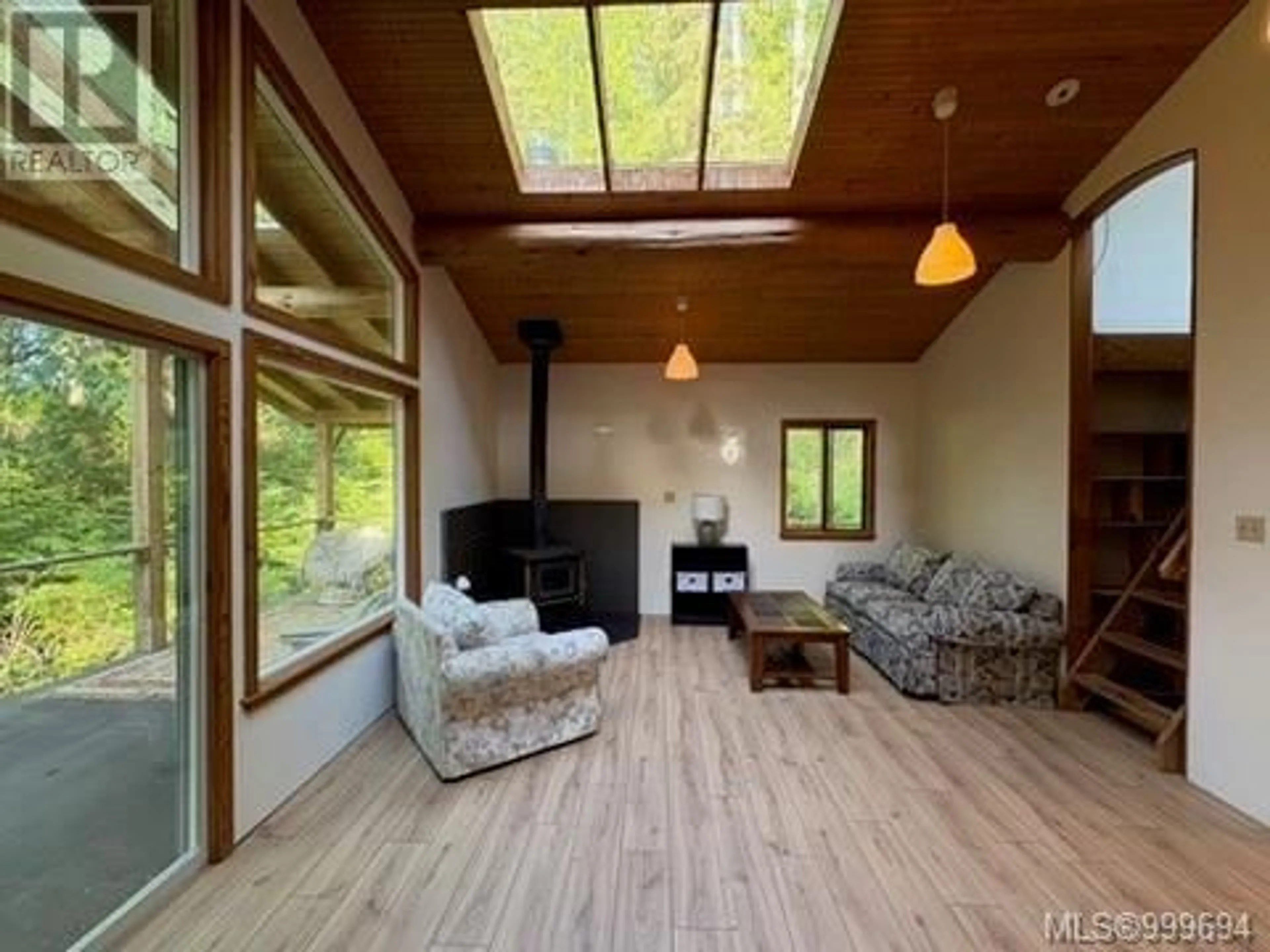 Living room with furniture, wood/laminate floor for 421 WHALETOWN ROAD, Cortes Island British Columbia V0P1Z0