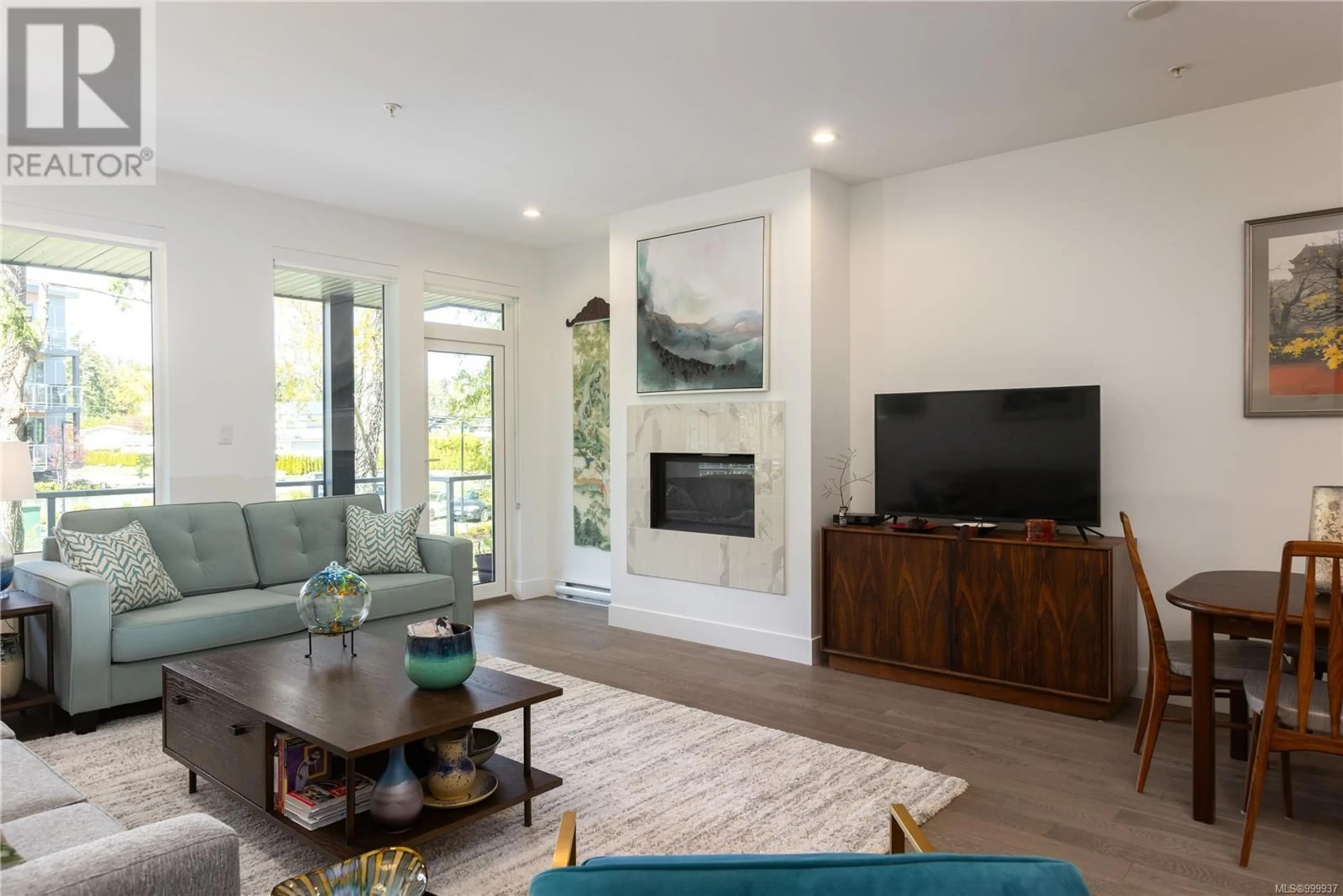 Living room with furniture, wood/laminate floor for 205 - 10660 MCDONALD PARK ROAD, North Saanich British Columbia V8L5S7