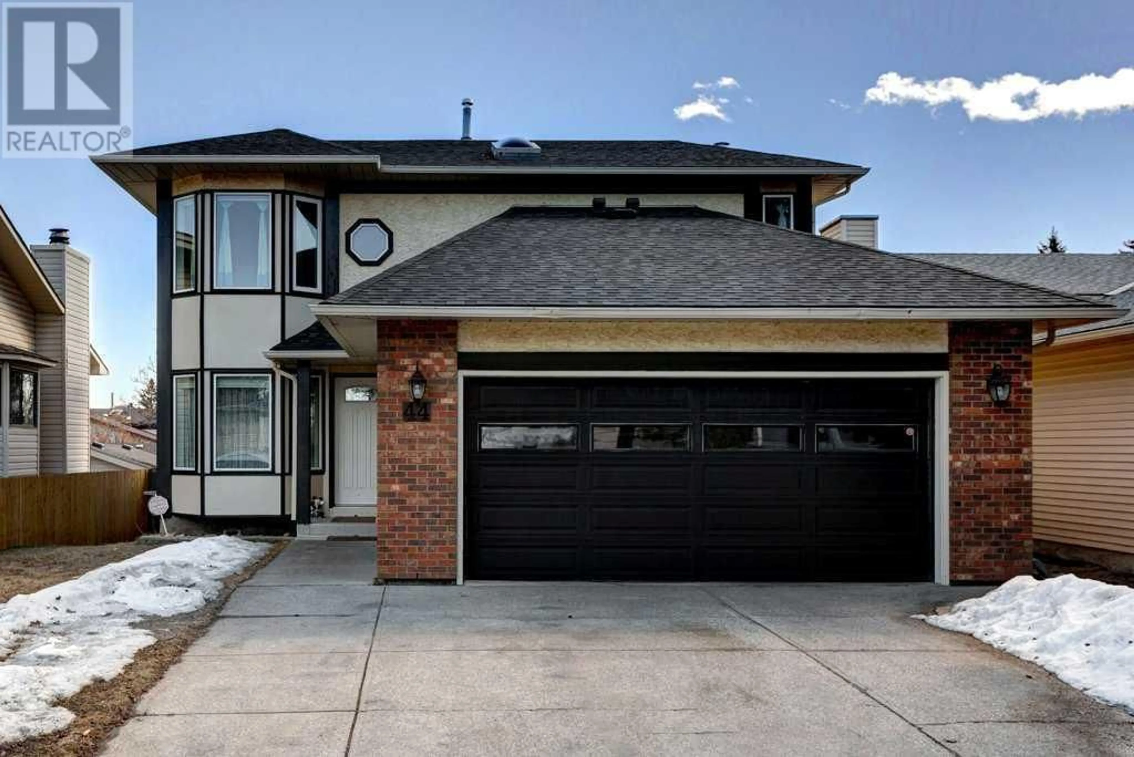 Home with brick exterior material for 44 Woodfern Way SW, Calgary Alberta T2W4S7