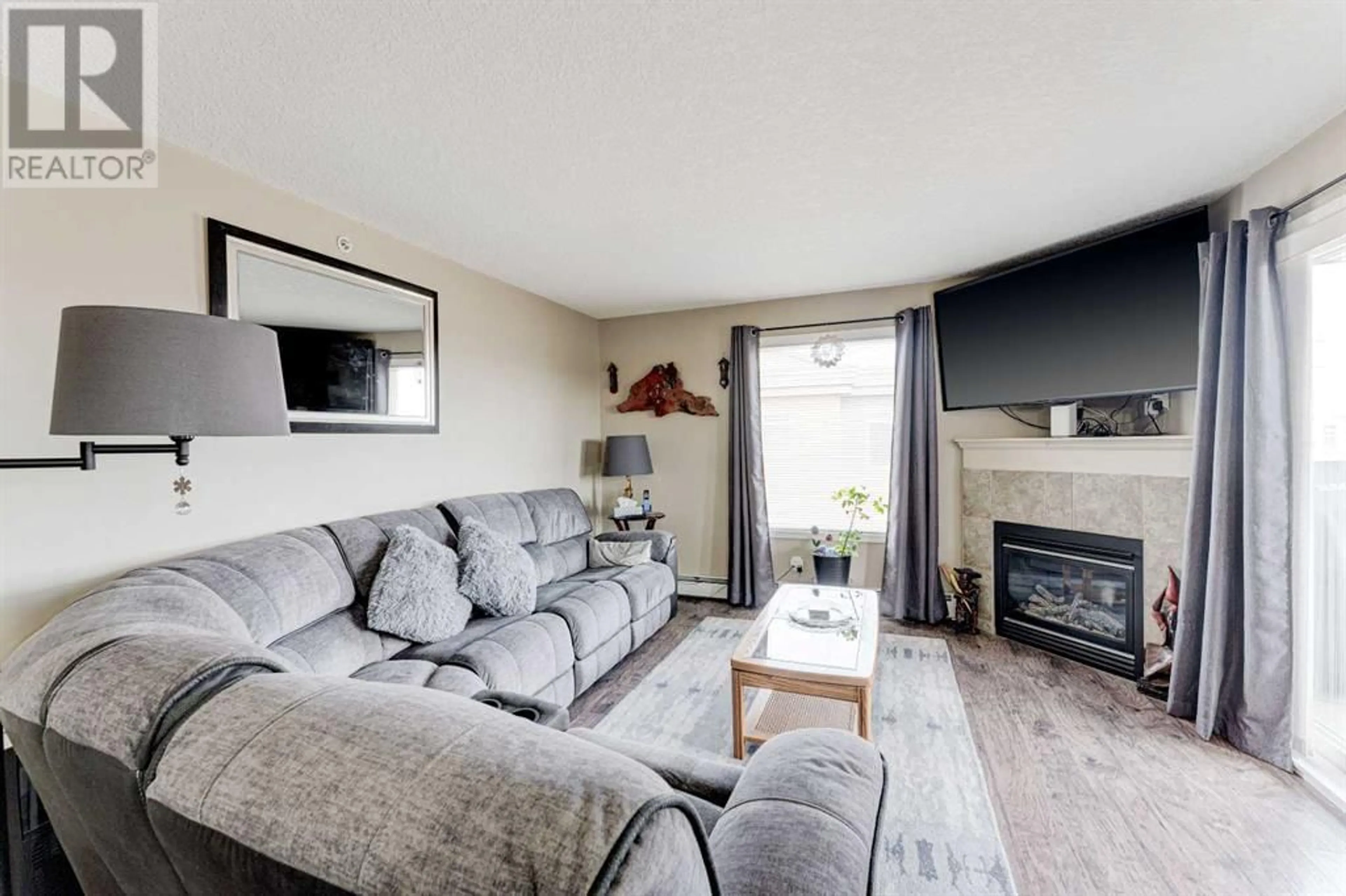 Living room for 8429 304 Mackenzie Way SW, Airdrie Alberta T4B3H7