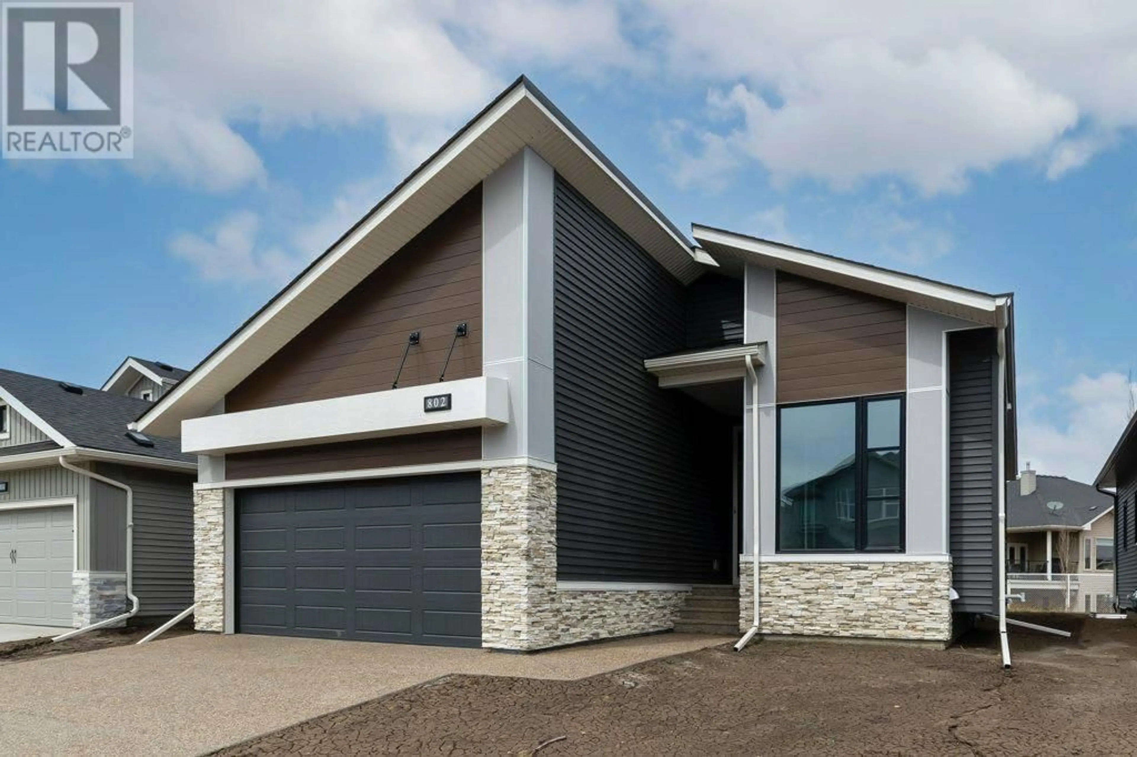 Home with brick exterior material for 802 Mandalay Link, Carstairs Alberta T0M0N0