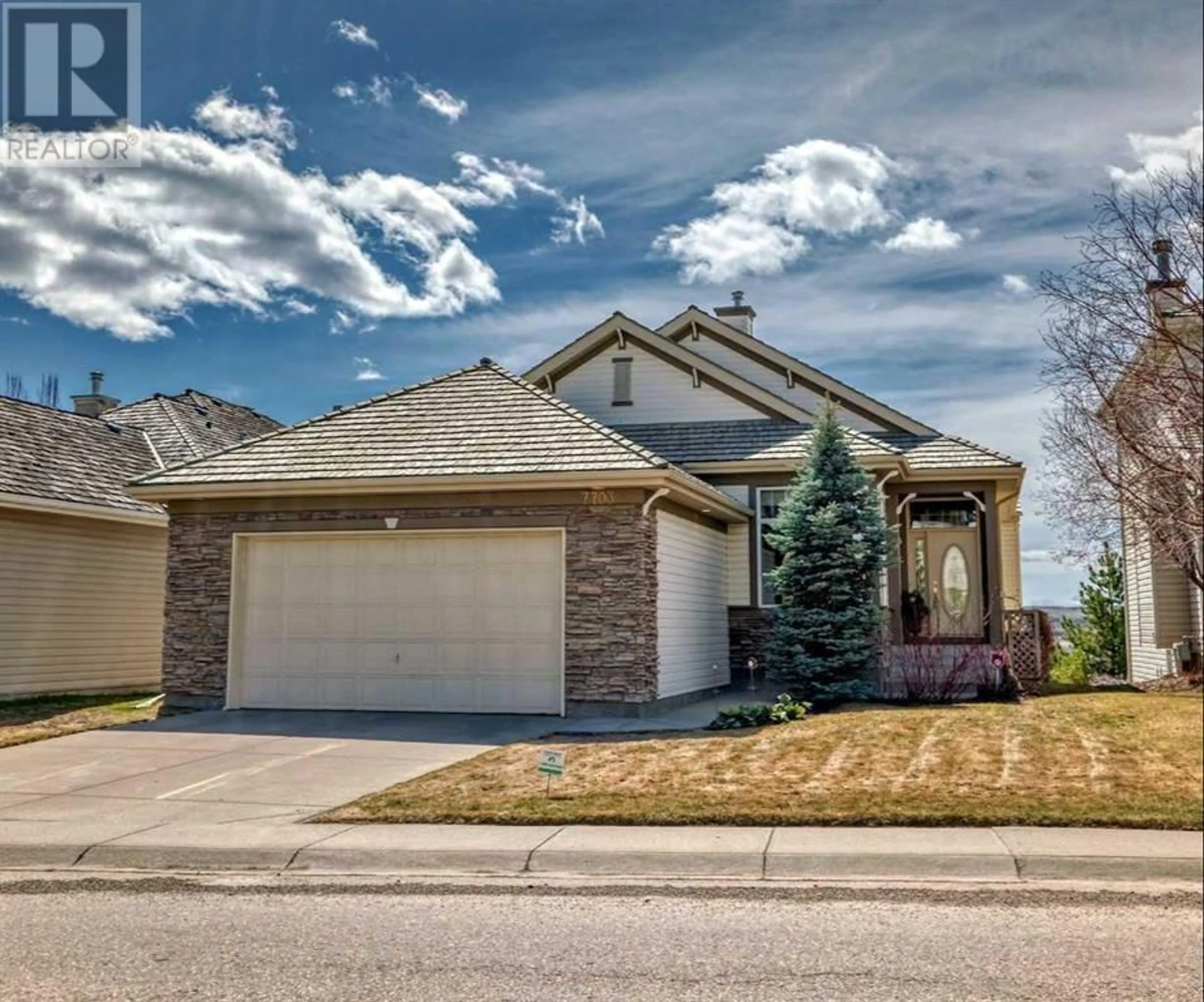 Frontside or backside of a home for 7703 Springbank Way SW, Calgary Alberta T3H4L8
