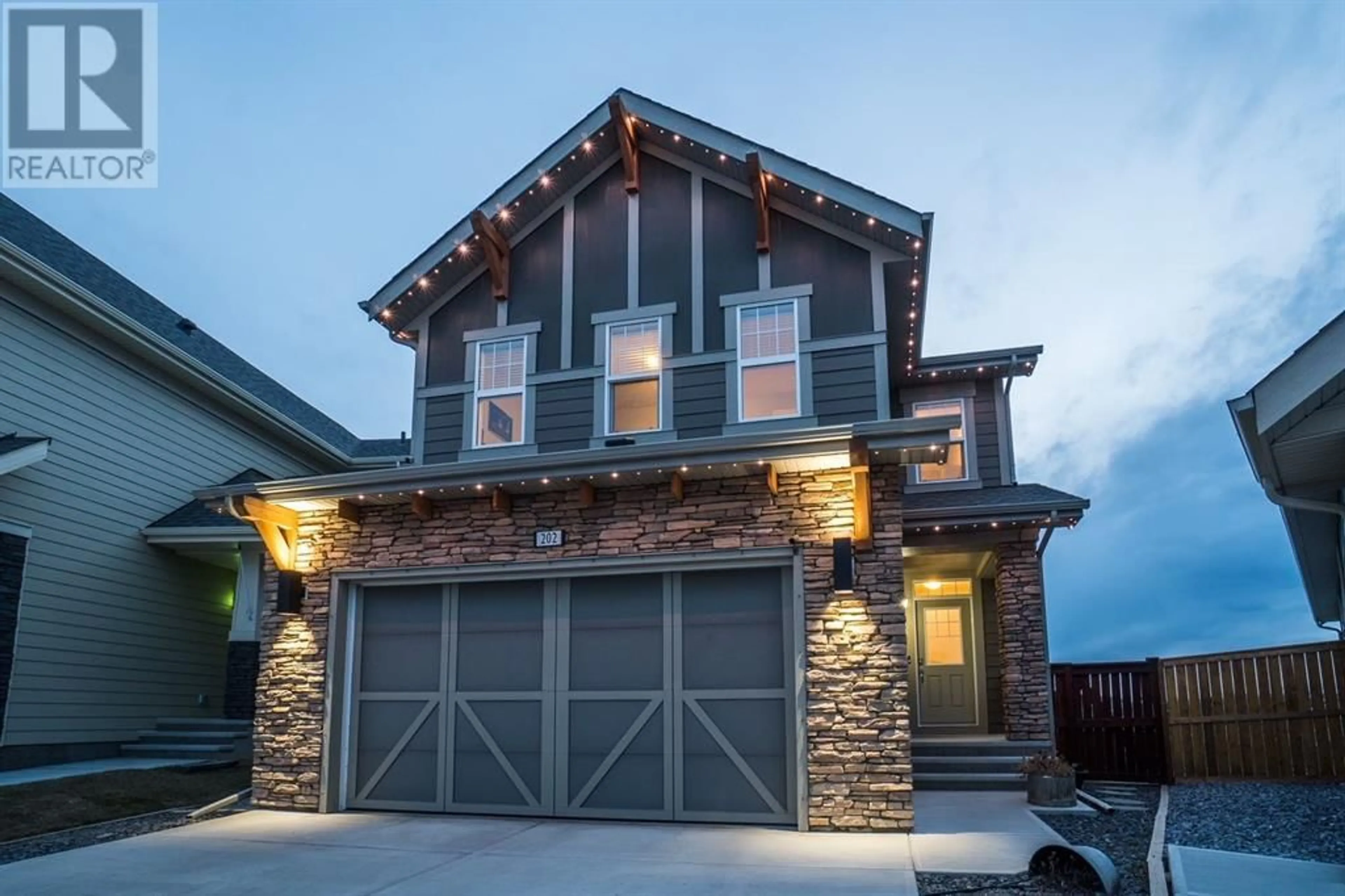 Home with brick exterior material for 202 Riviera View, Cochrane Alberta T4C1Z2