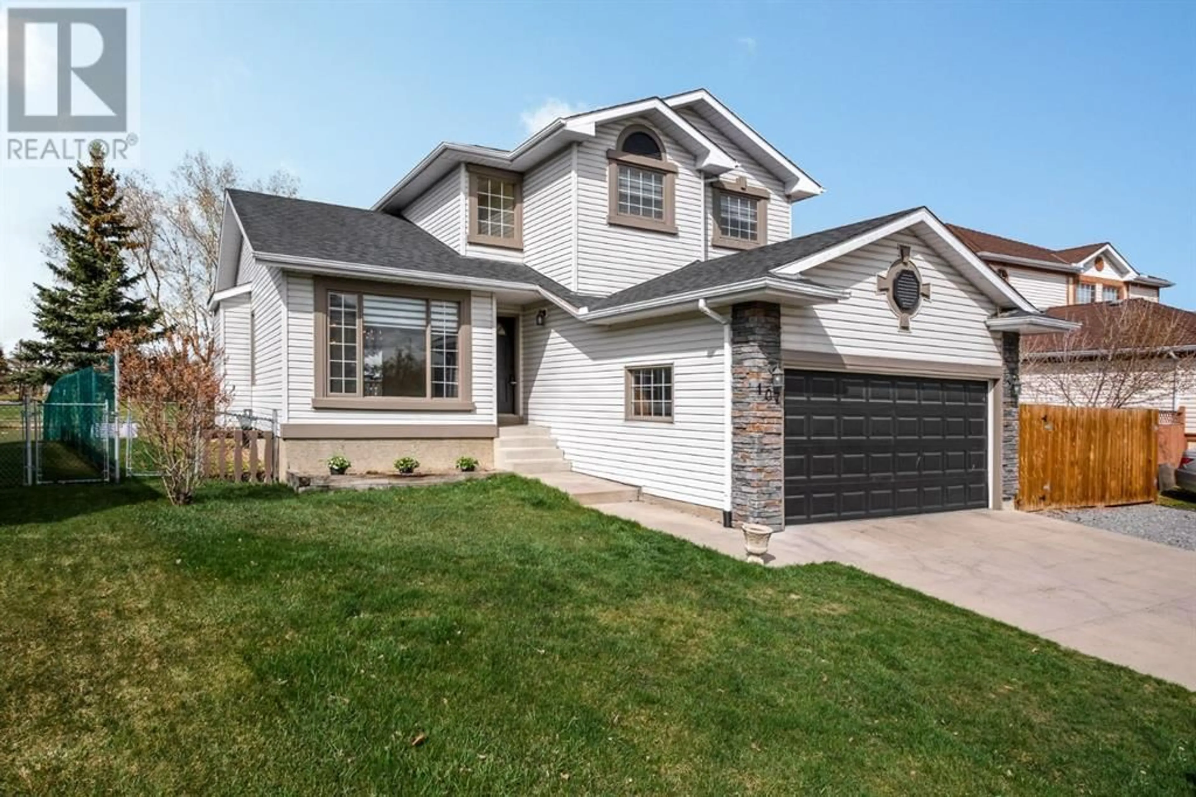 Frontside or backside of a home for 107 Woodside Road NW, Airdrie Alberta T4B2E3