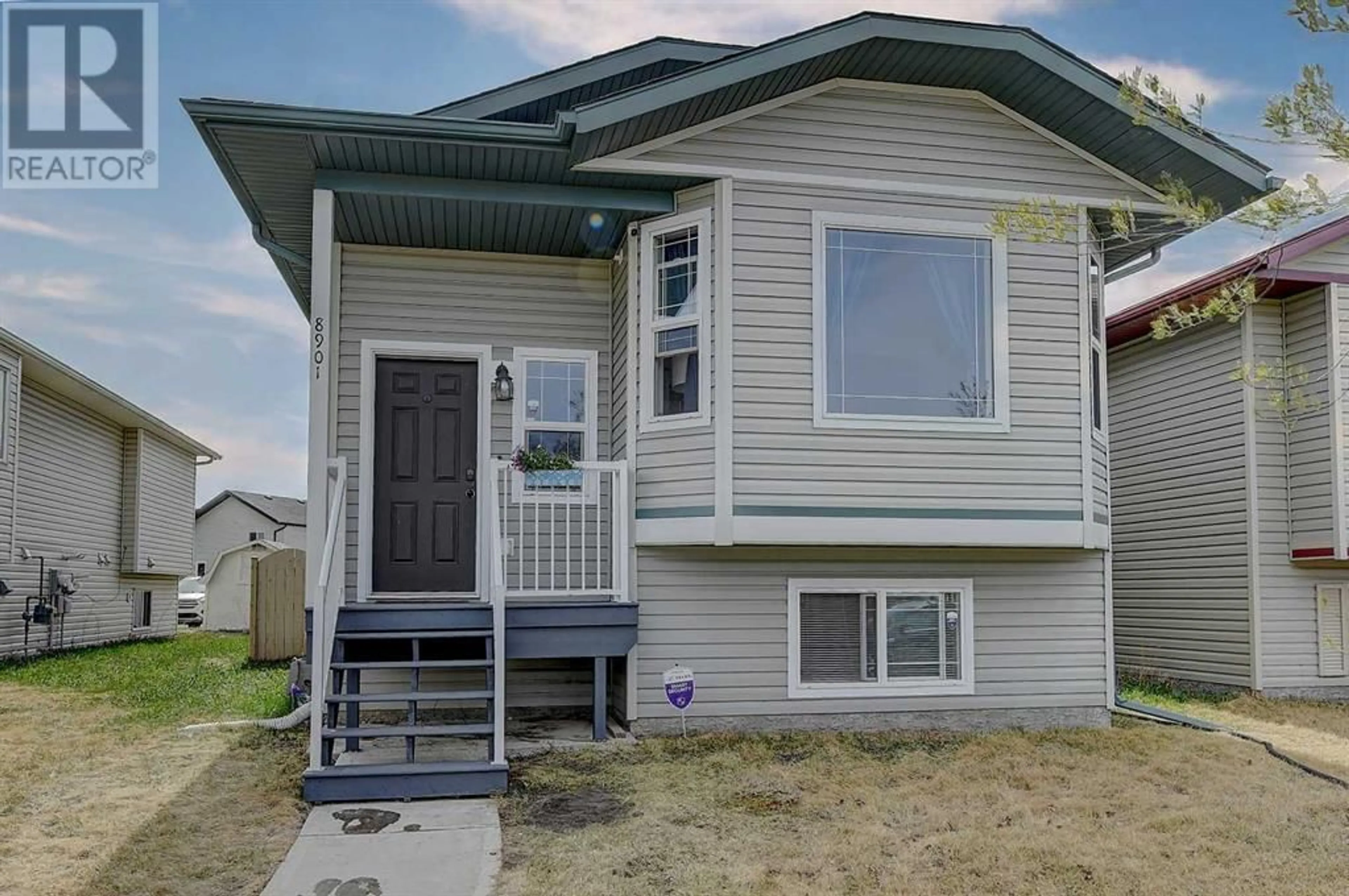 Home with vinyl exterior material for 8901 72 Avenue, Grande Prairie Alberta T8X0E1