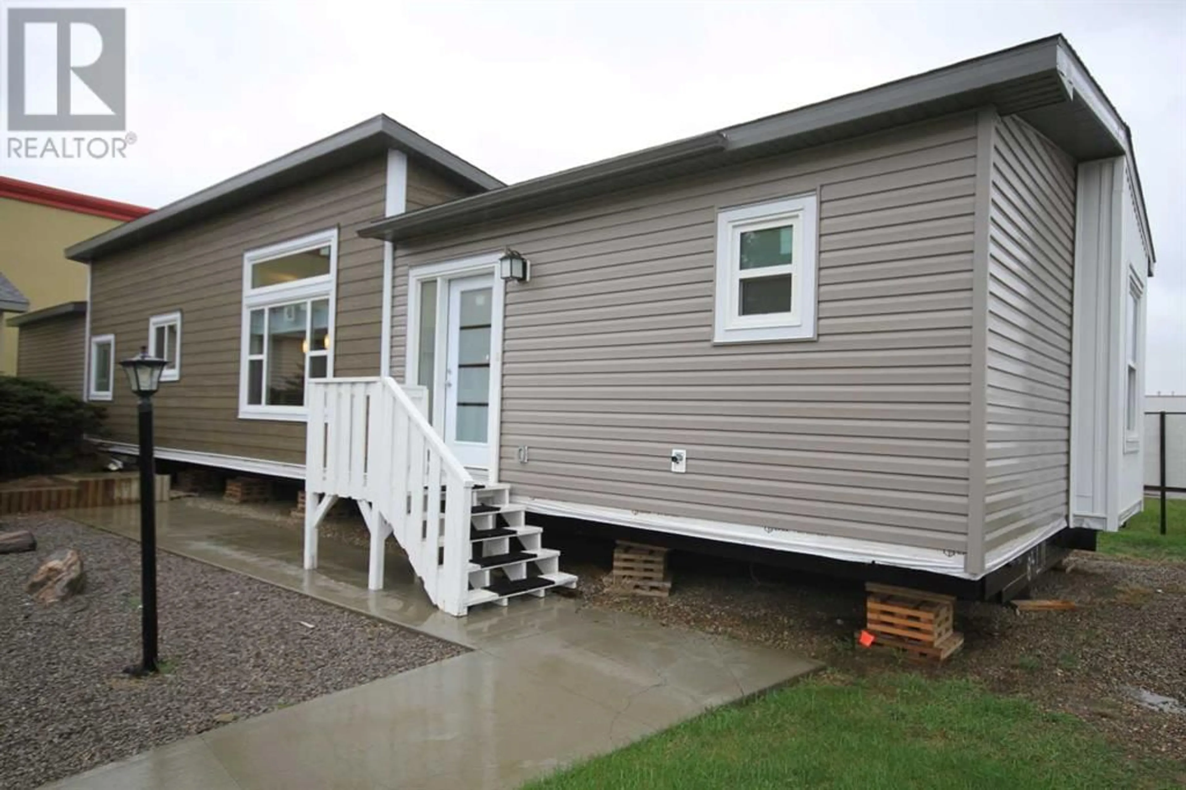 Home with vinyl exterior material for 7049 48 Street, Taber Alberta T1G0G7