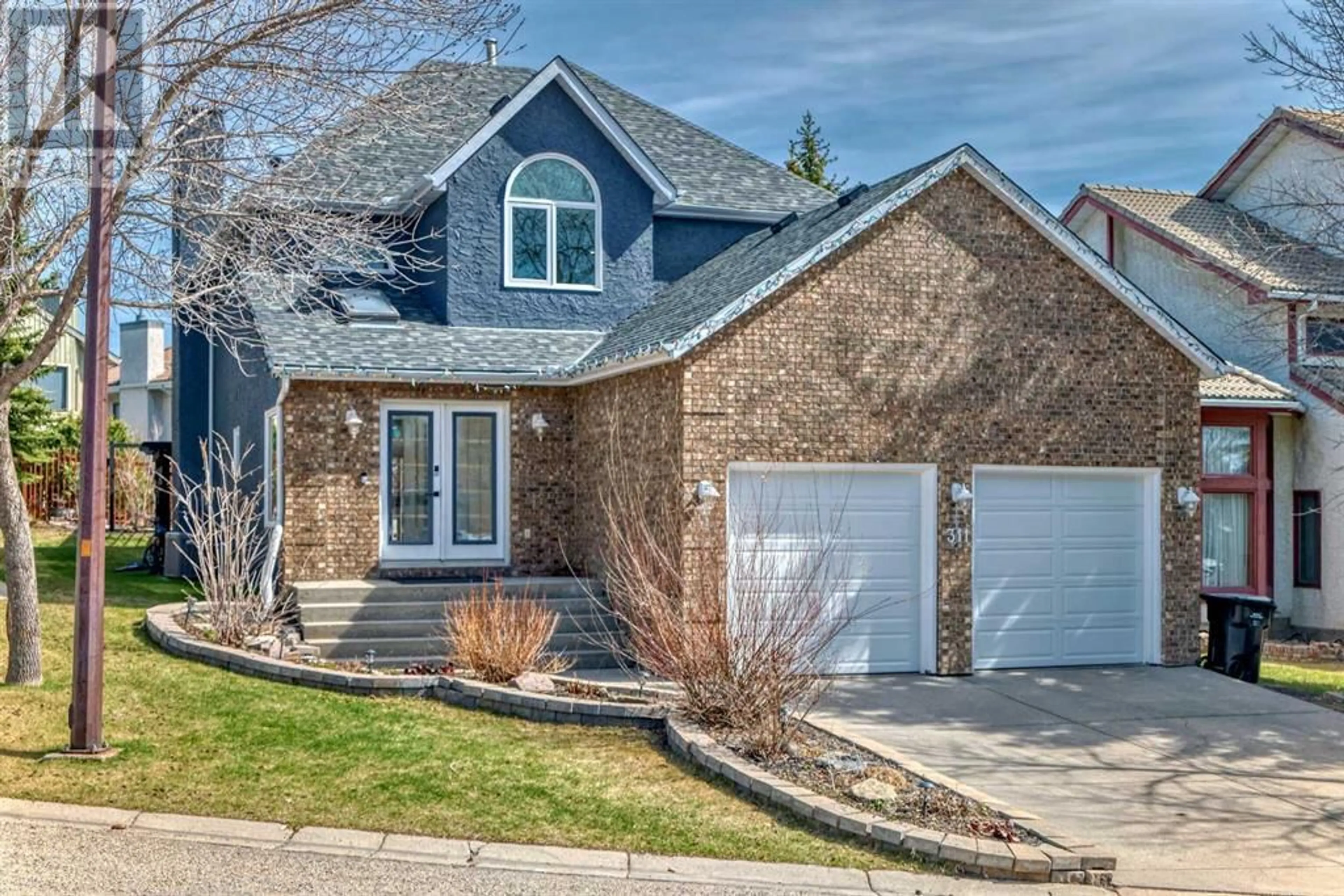 Home with brick exterior material for 311 Edelweiss Place NW, Calgary Alberta T3A3R2