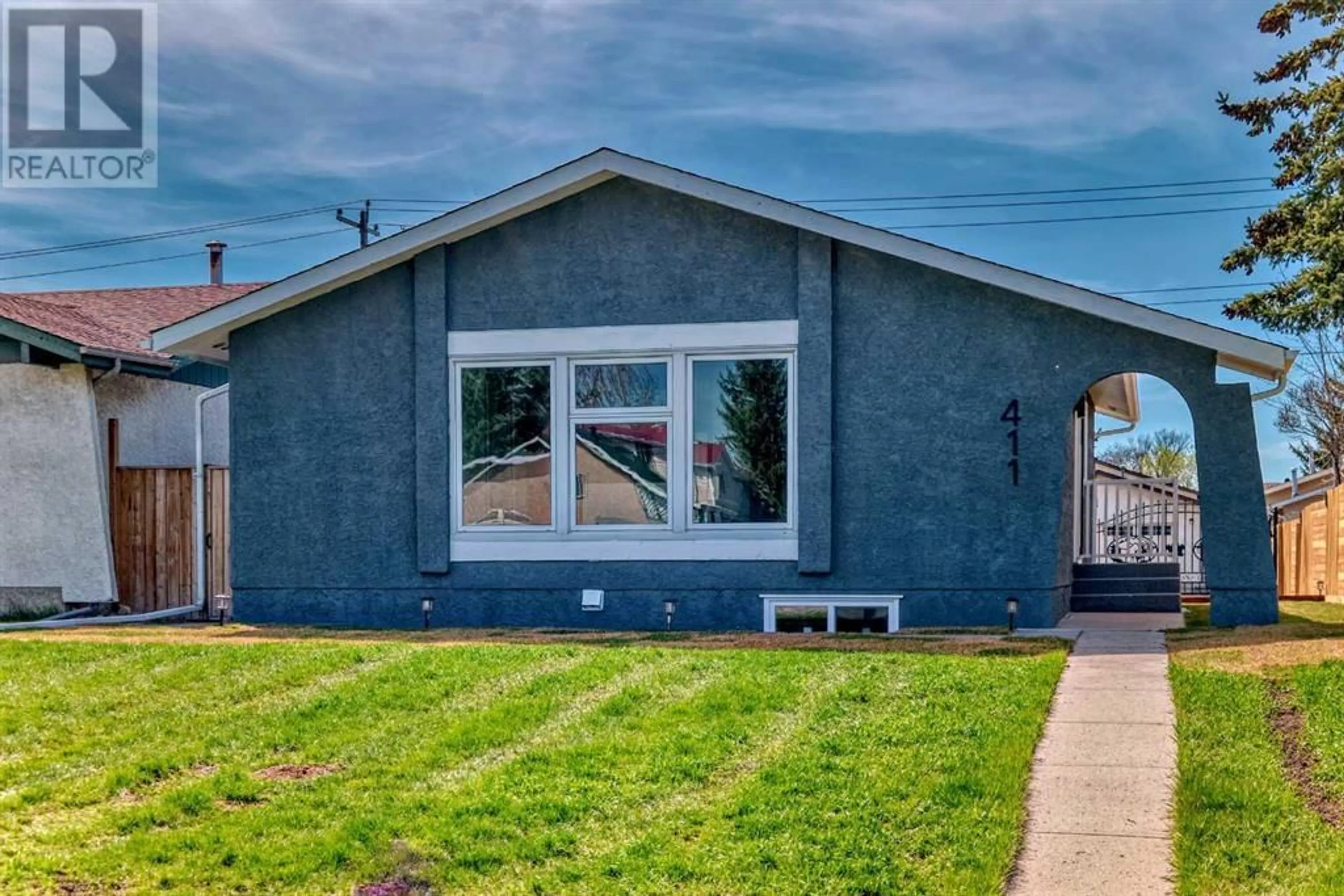 Frontside or backside of a home for 411 68 Street NE, Calgary Alberta T2A5J6