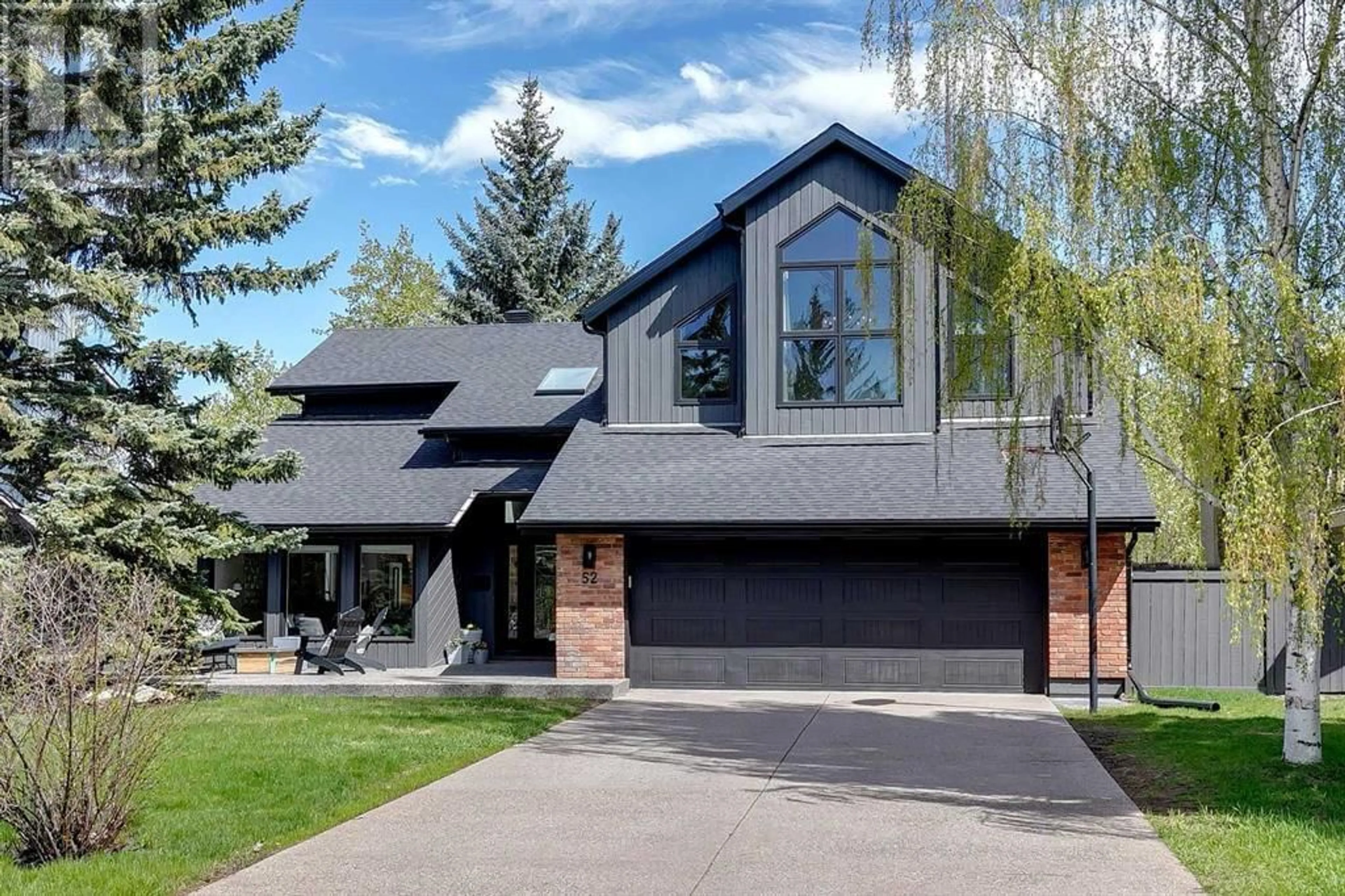 Home with brick exterior material for 52 Bow Village Crescent NW, Calgary Alberta T3B4X2