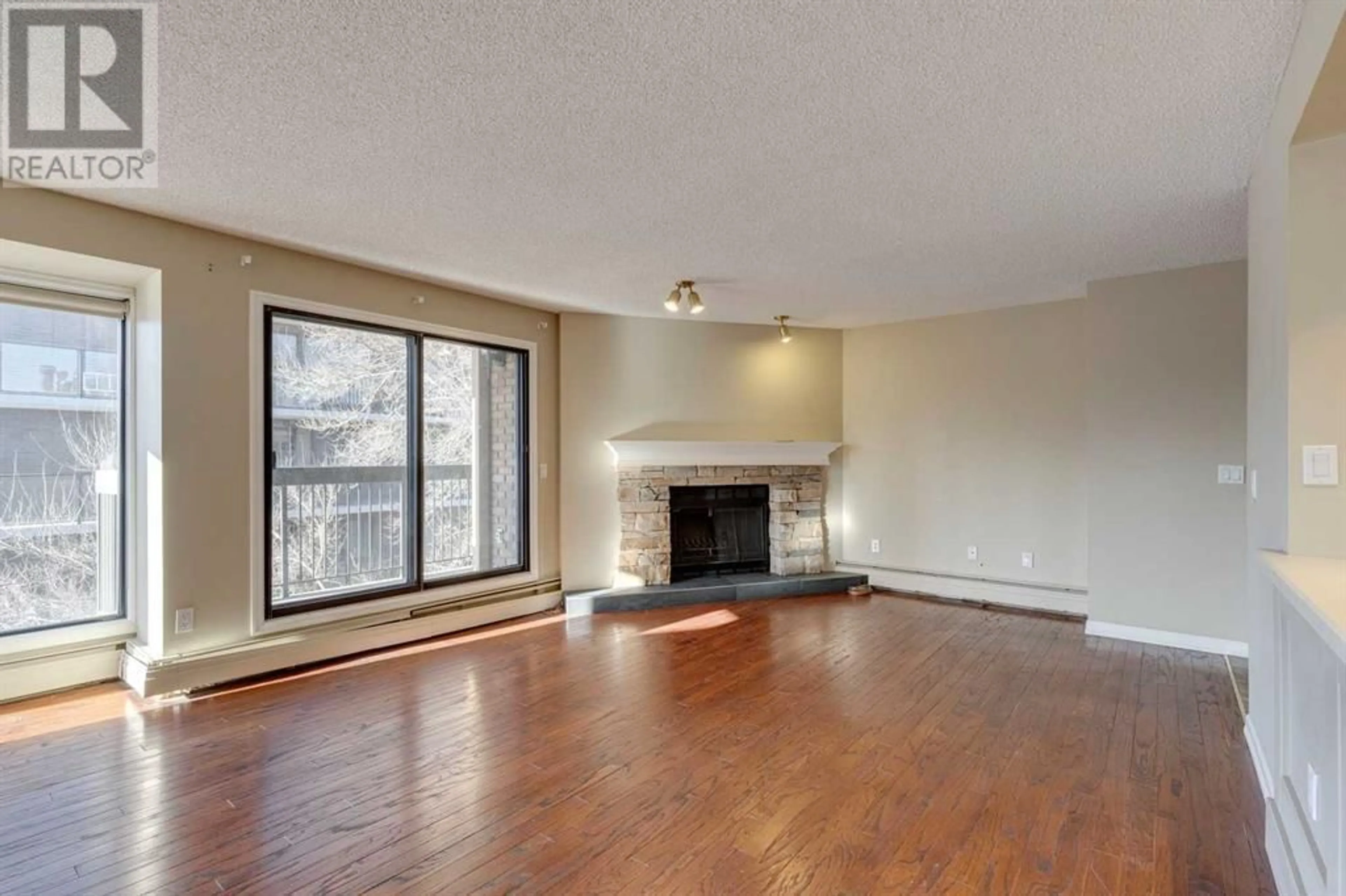 Living room with furniture, wood/laminate floor for 807 320 Meredith Road NE, Calgary Alberta T2E5A6