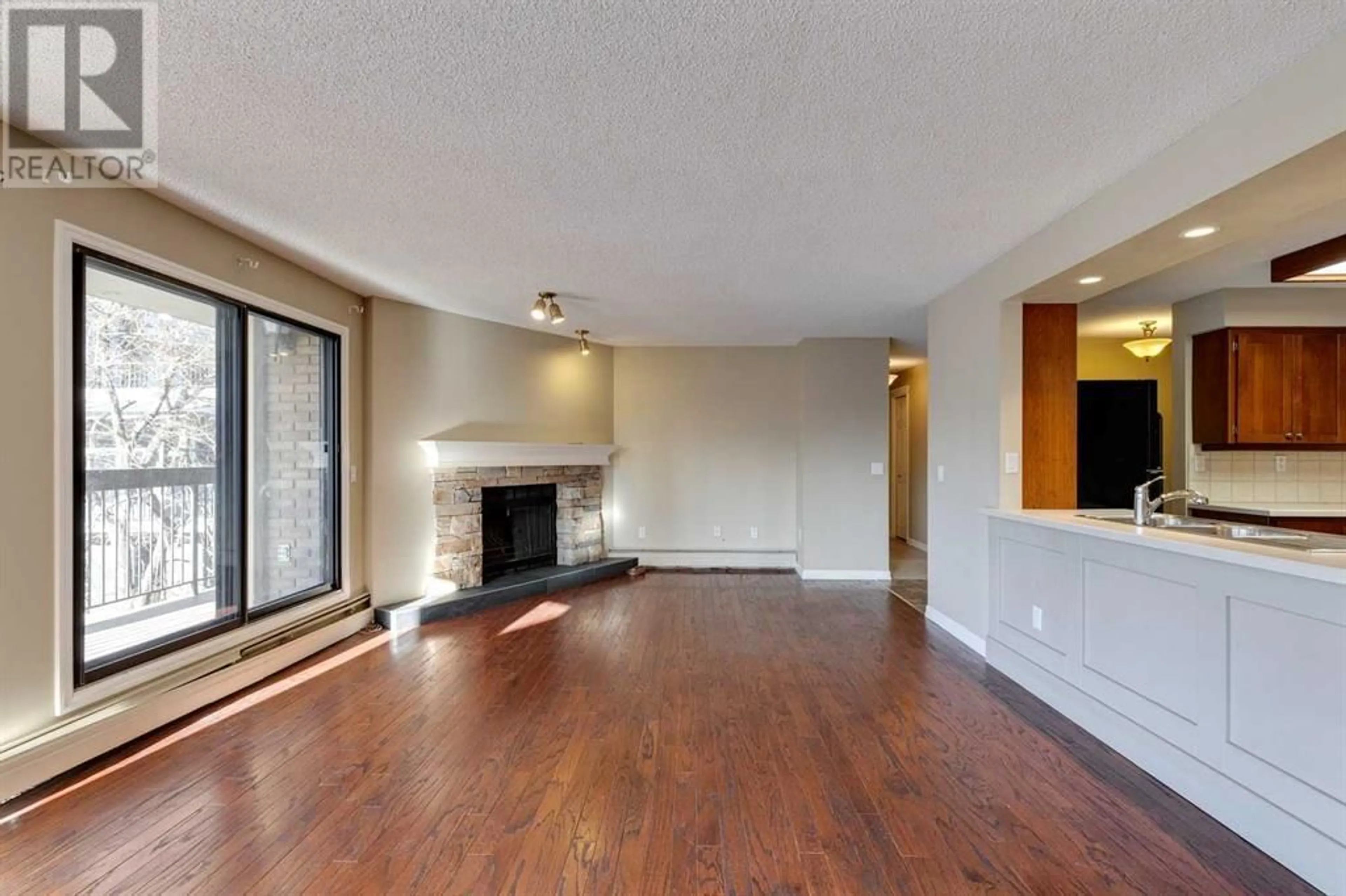 Living room with furniture, wood/laminate floor for 807 320 Meredith Road NE, Calgary Alberta T2E5A6