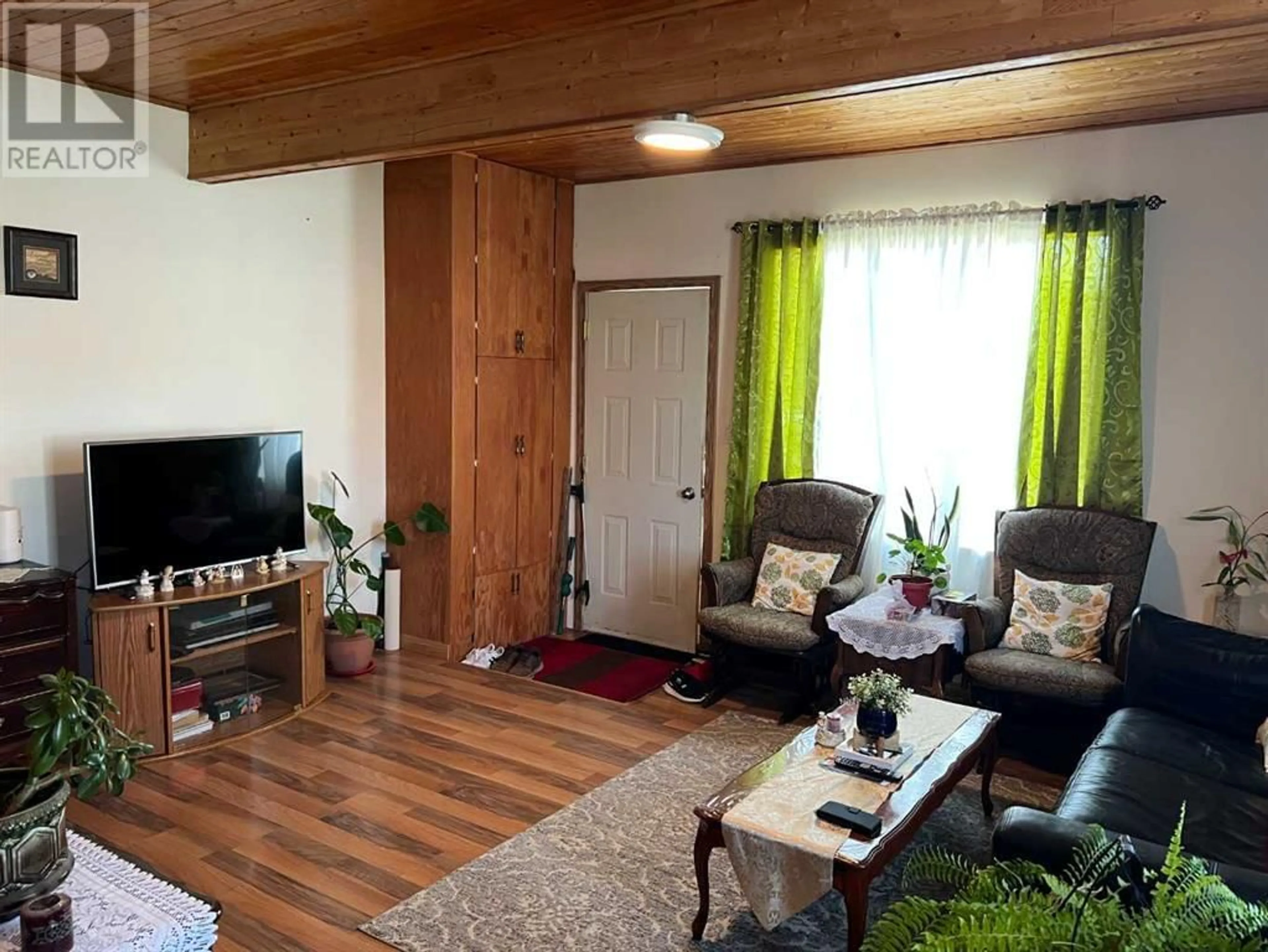 Living room with furniture, wood/laminate floor for 303 2 STREET NORTH, Vulcan Alberta T0L2B0