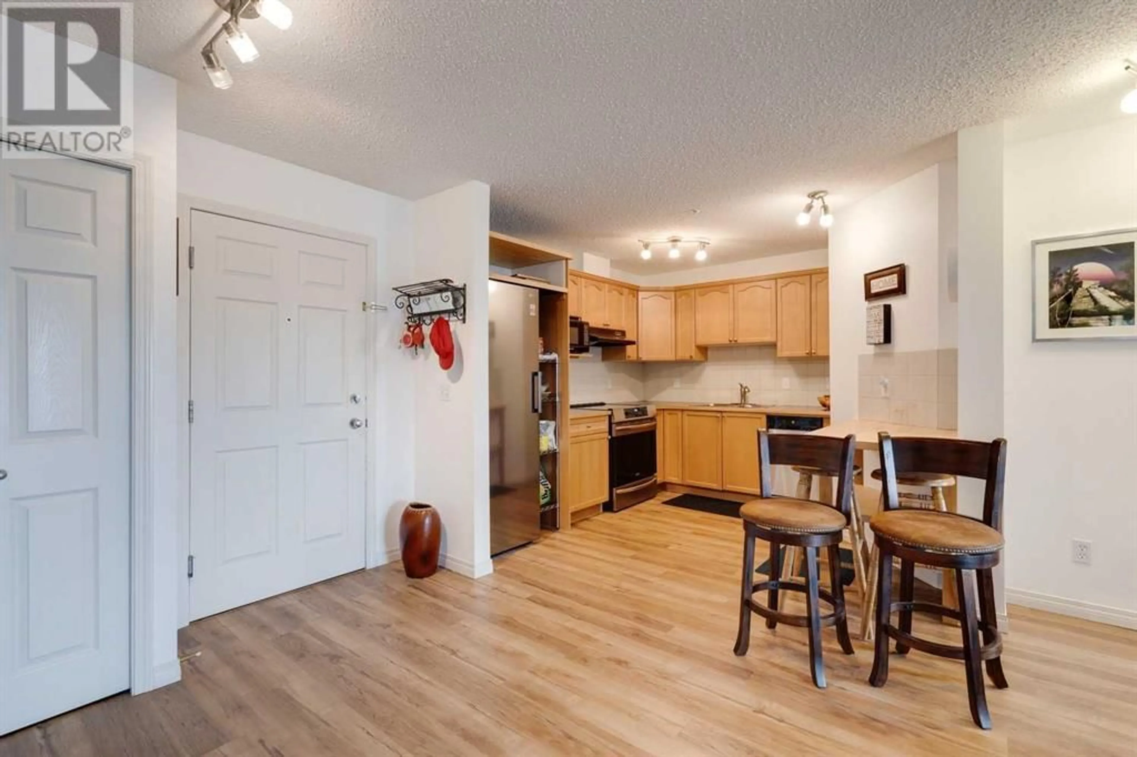 Open concept kitchen, wood/laminate floor for 128 CENTRE AVENUE, Cochrane Alberta T4C1Z4